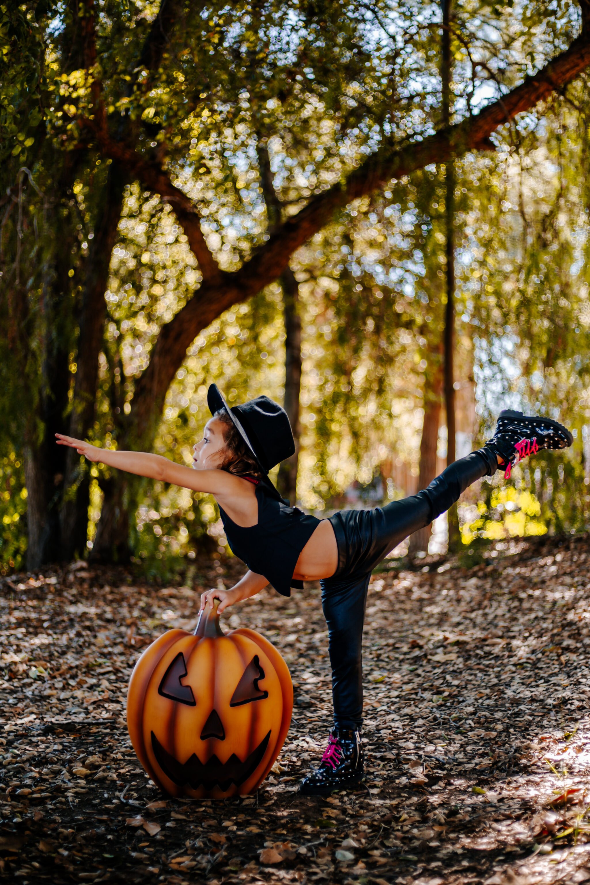 boy dancing by halloween pumpkin