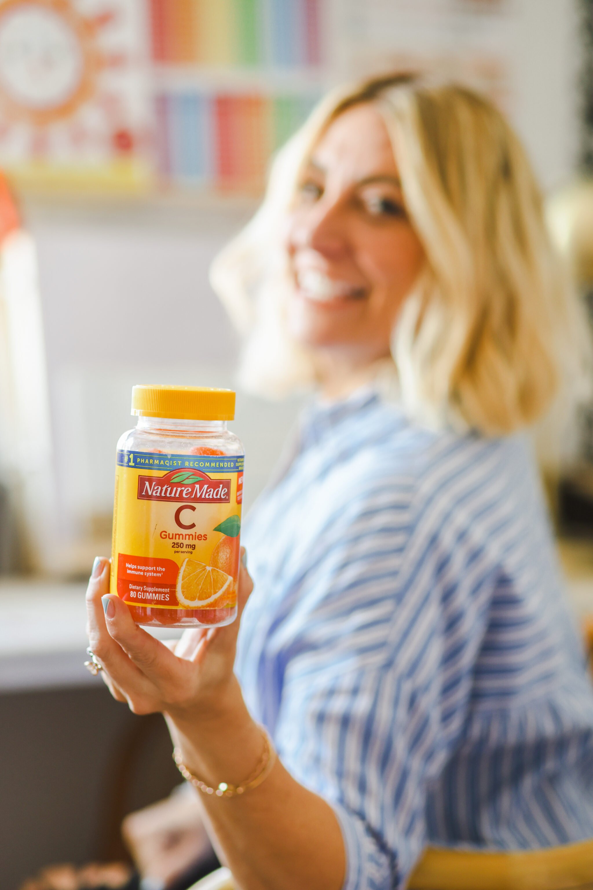 woman holding bottle of vitamins