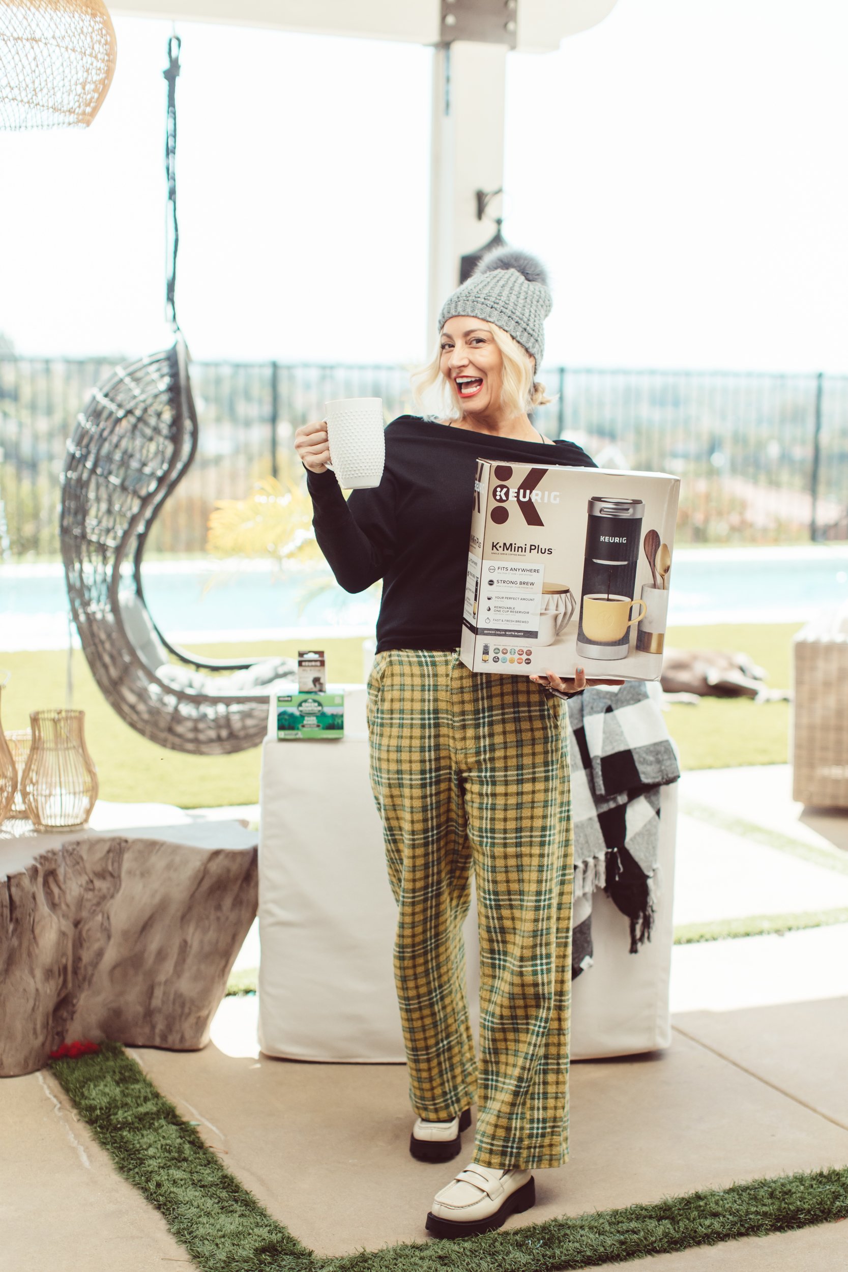 woman drinking coffee holding coffee maker