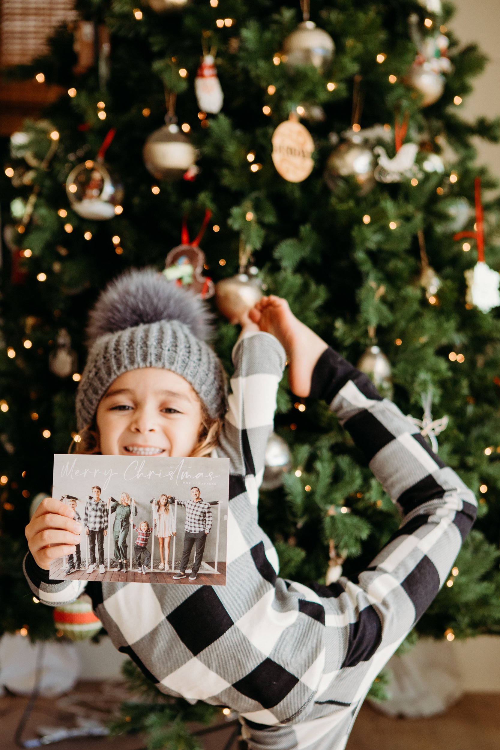 boy holding up a christmas card