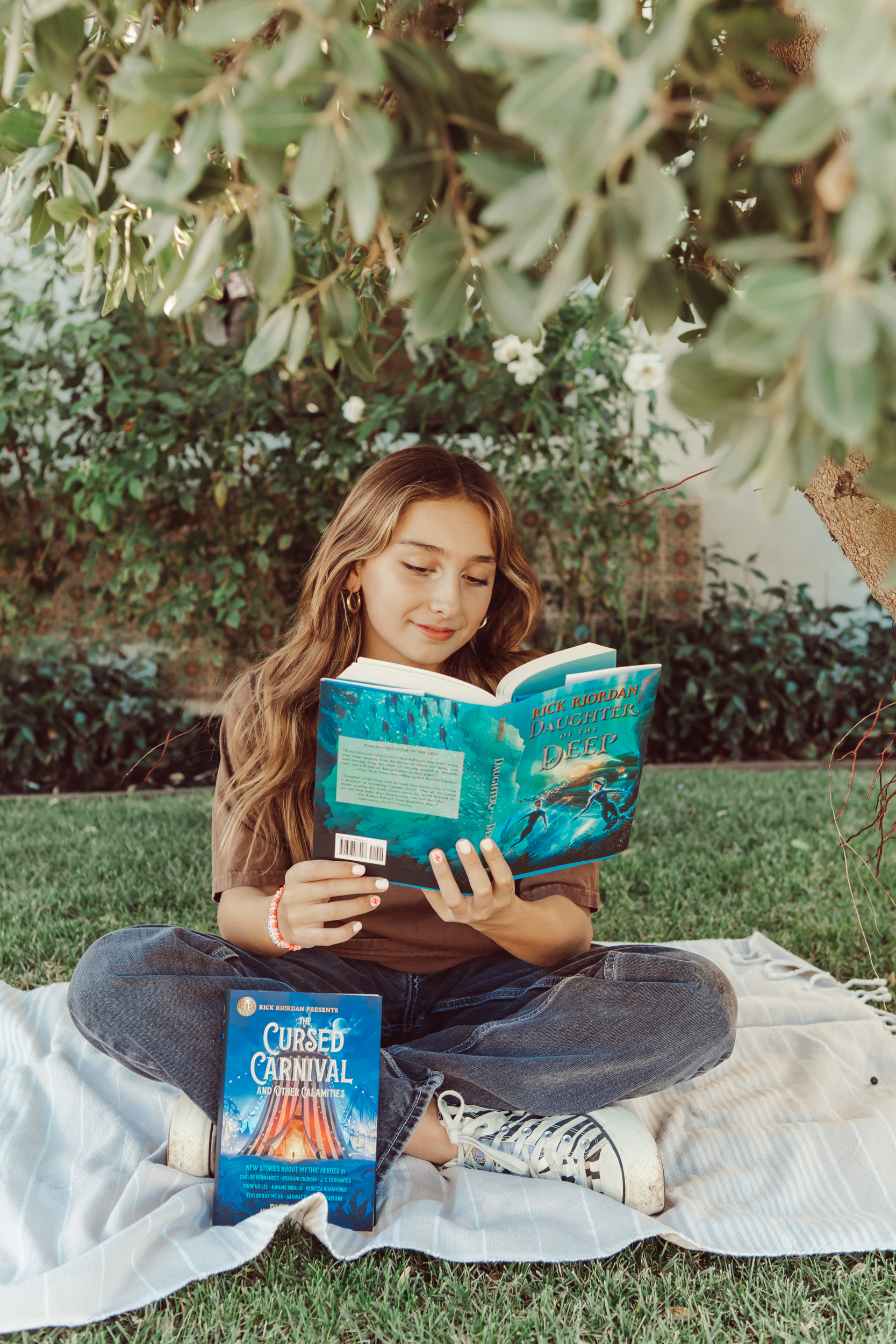 girl reading books on the grass
