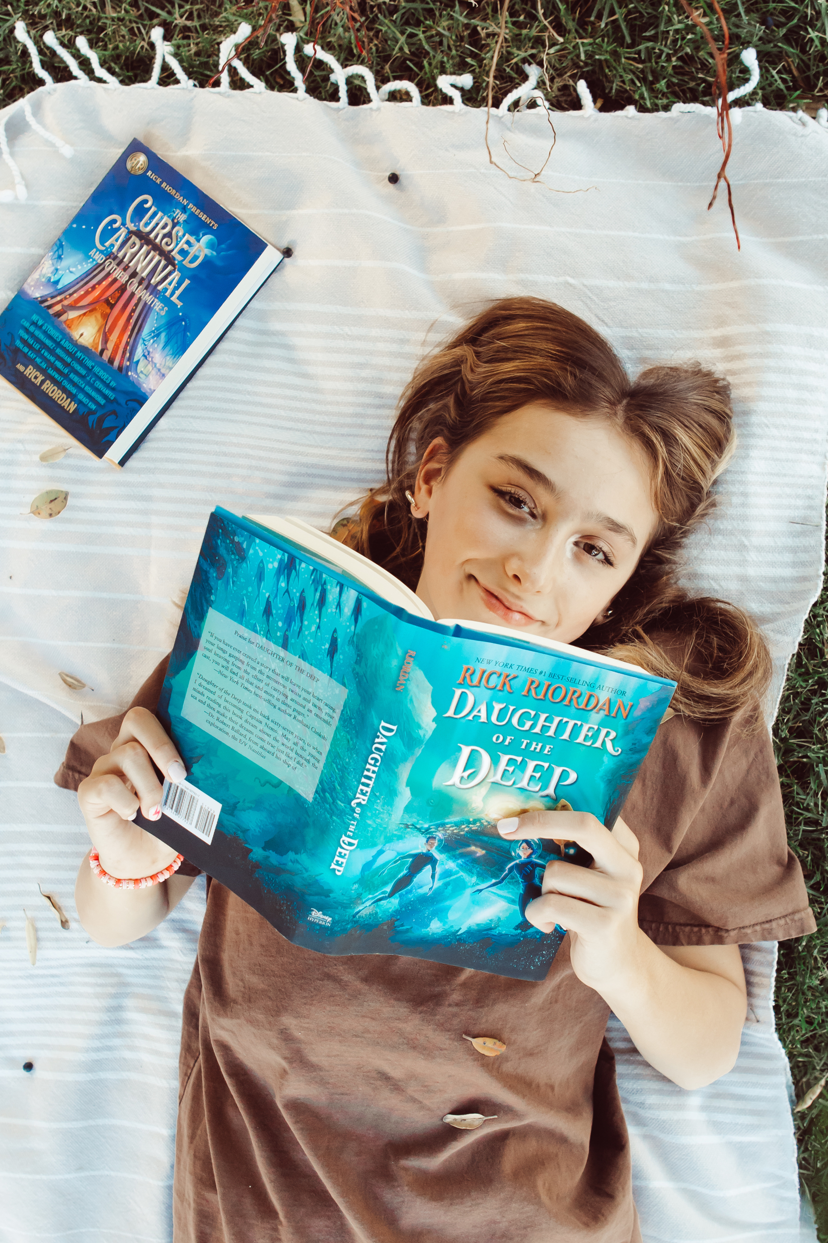 girl on blanket reading books