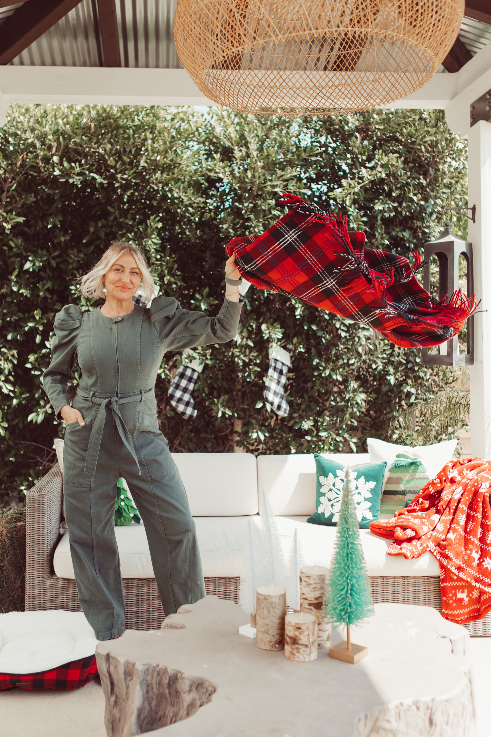 woman decorating her backyard for christmas