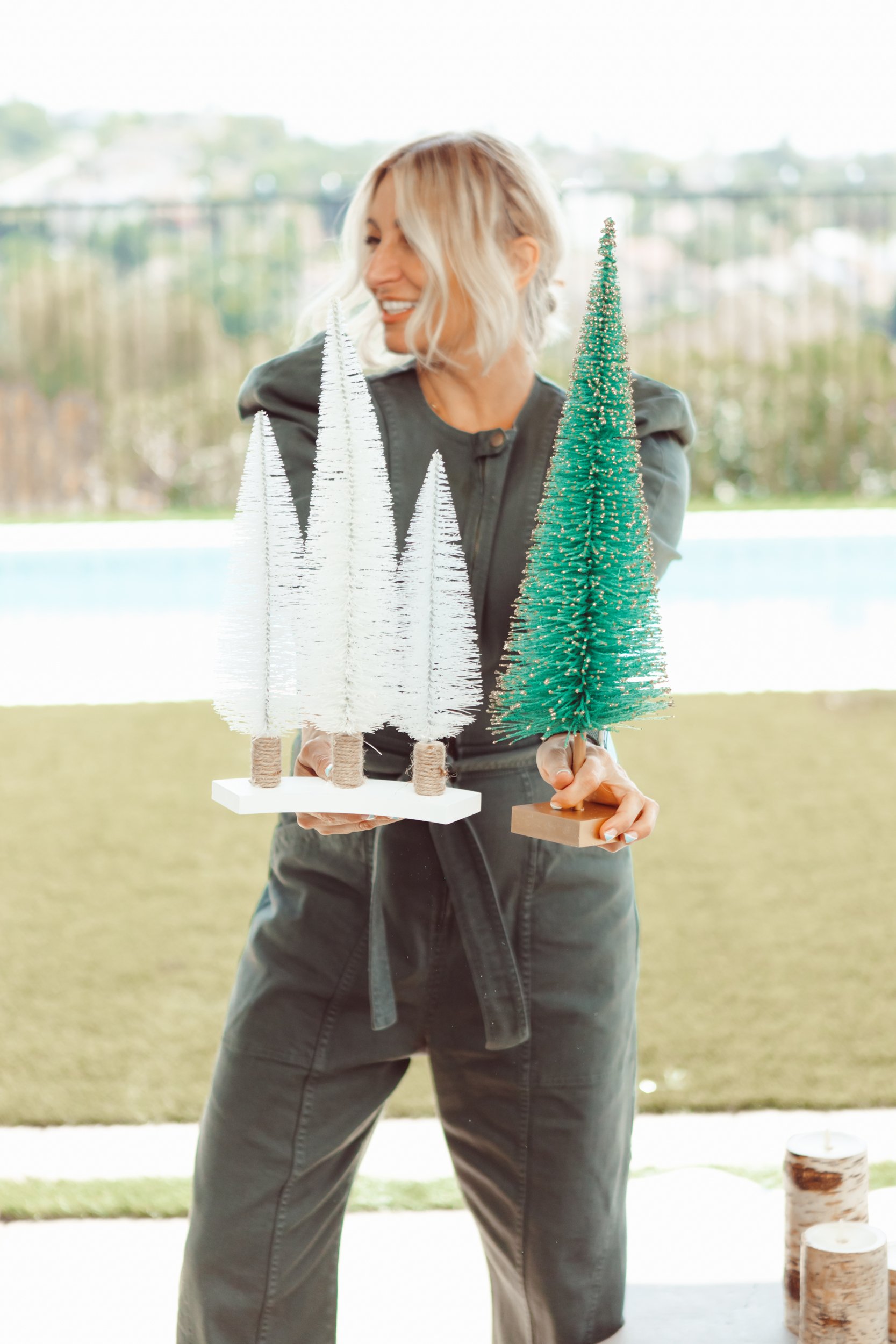 woman holding christmas trees