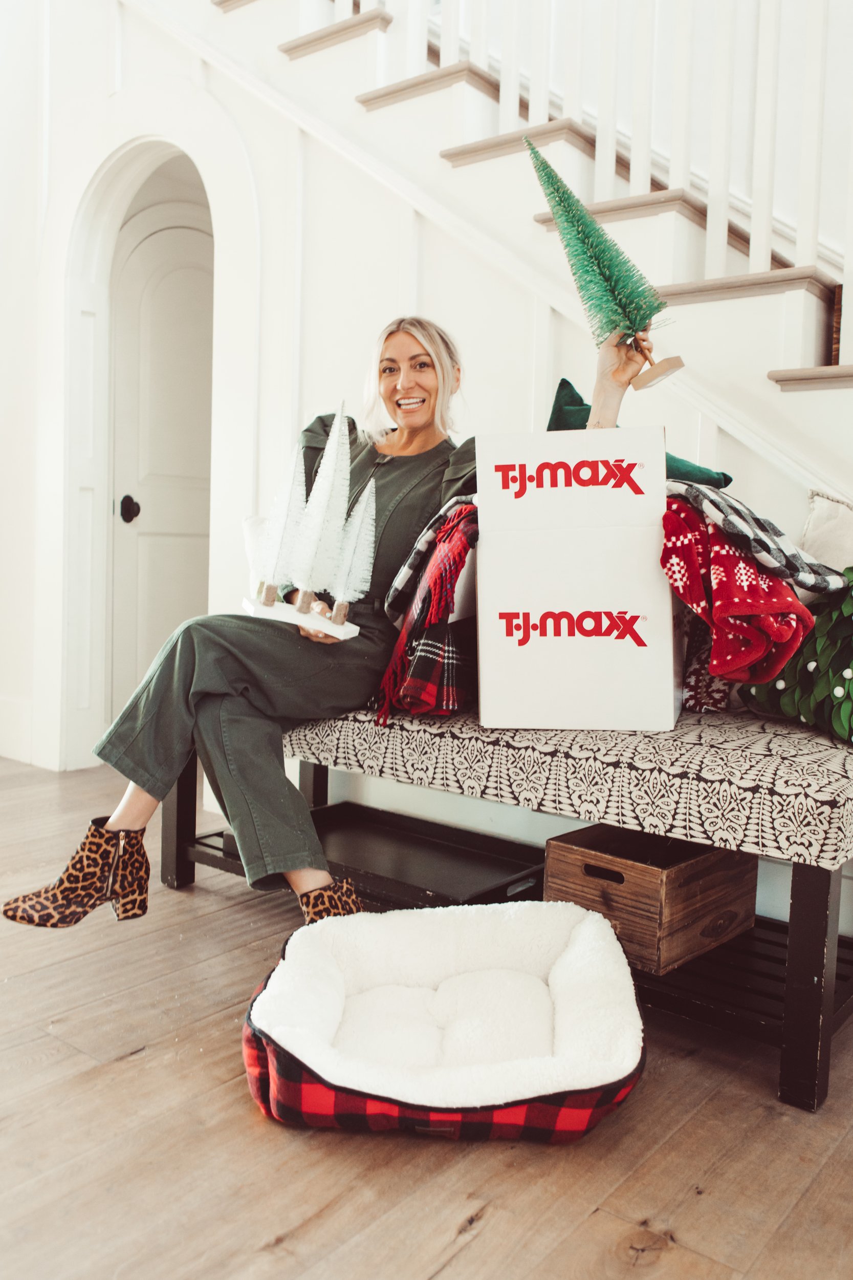 woman with christmas items and tjmaxx boxes