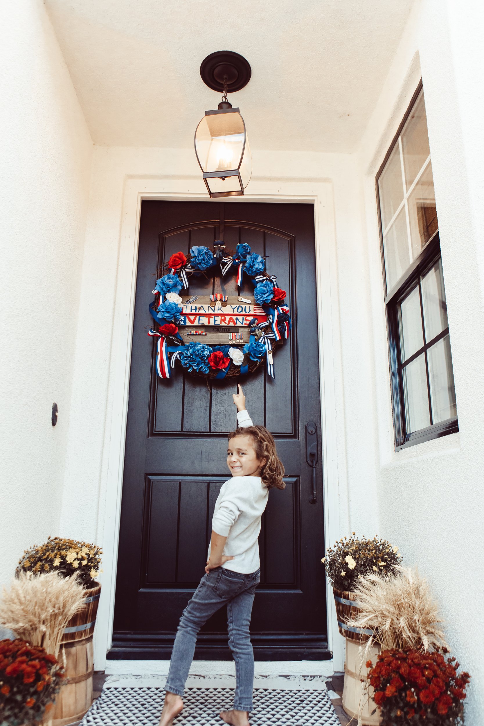 boy pointing to veterans day wreath