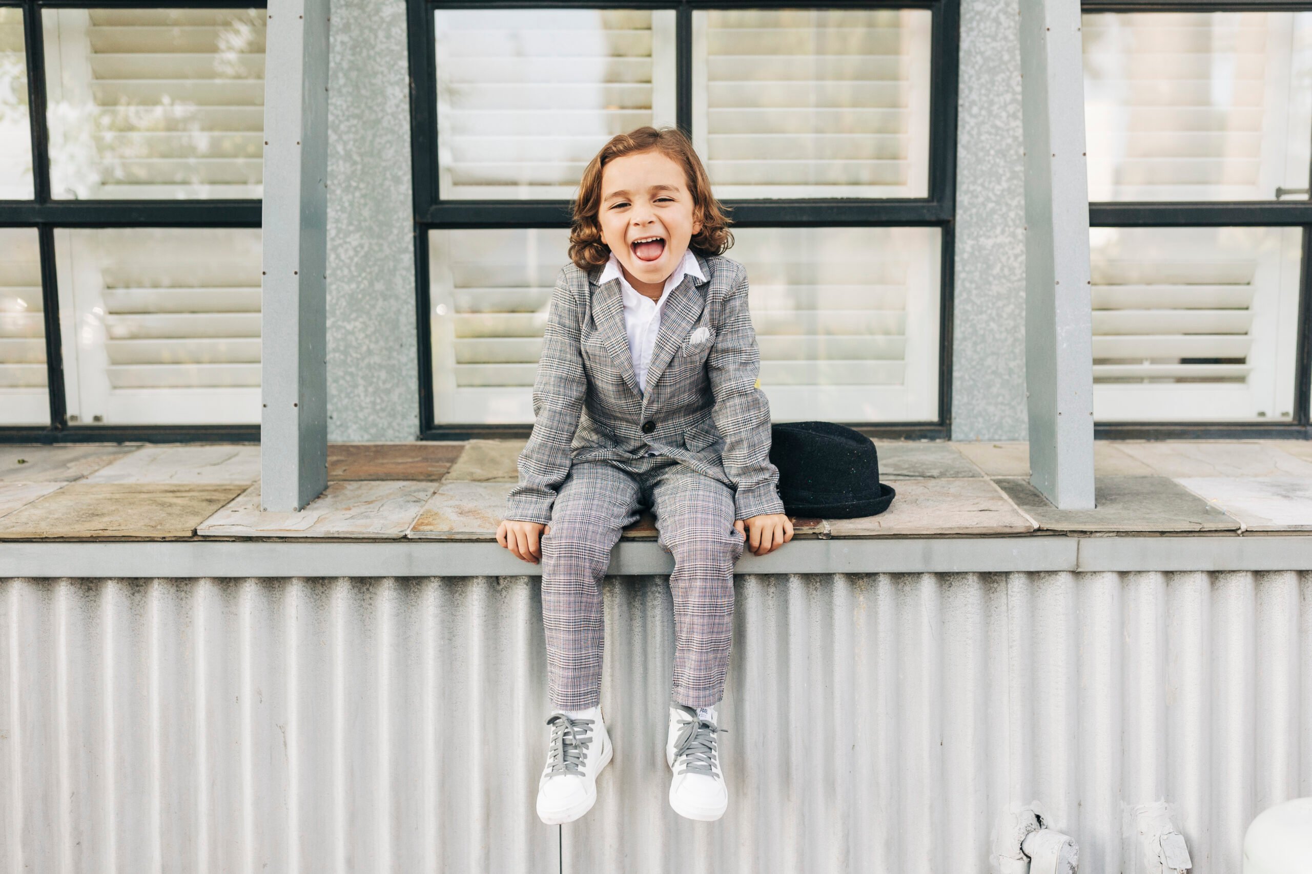 boy in suit laughing