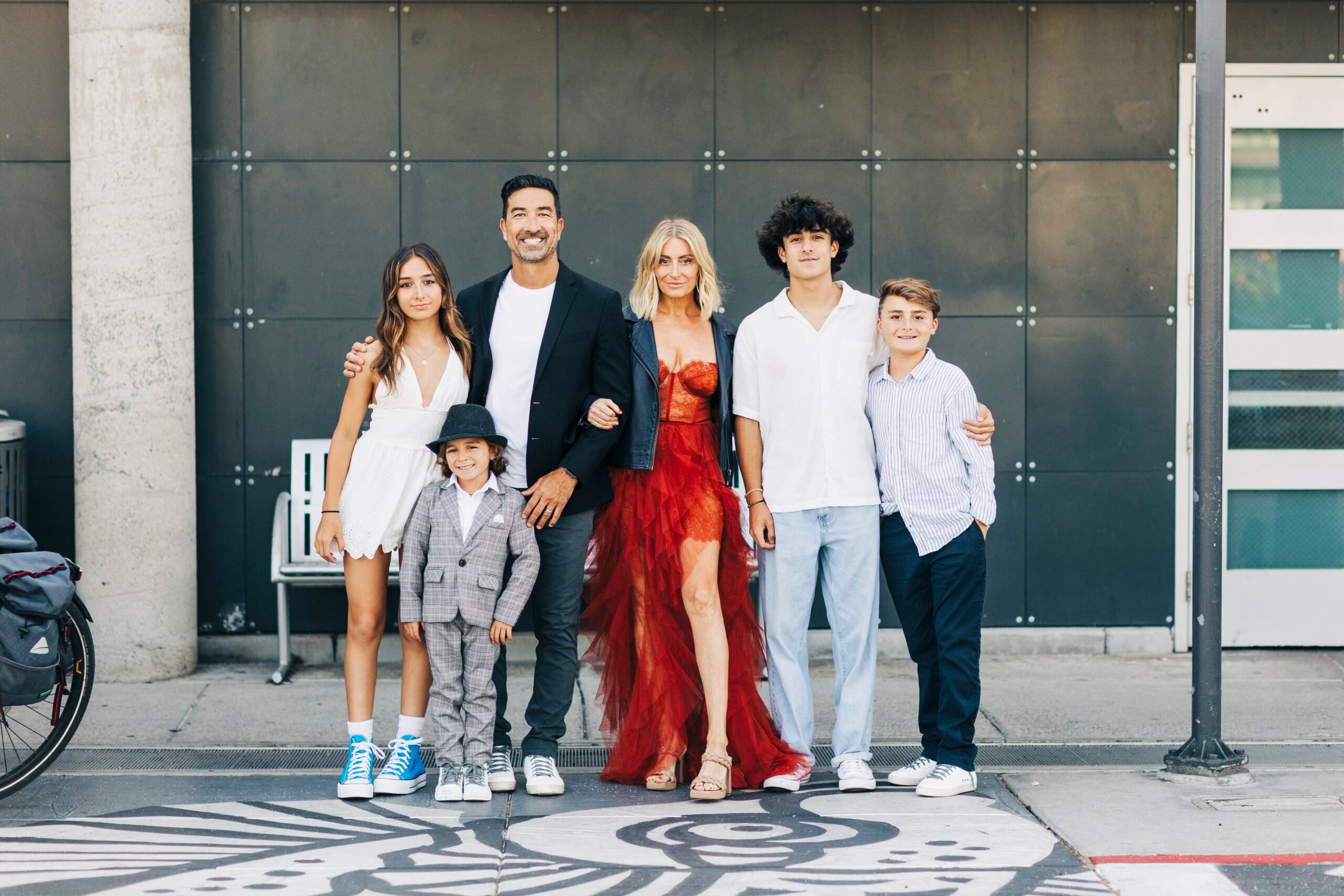 A well-dressed family is posing together for a picture.