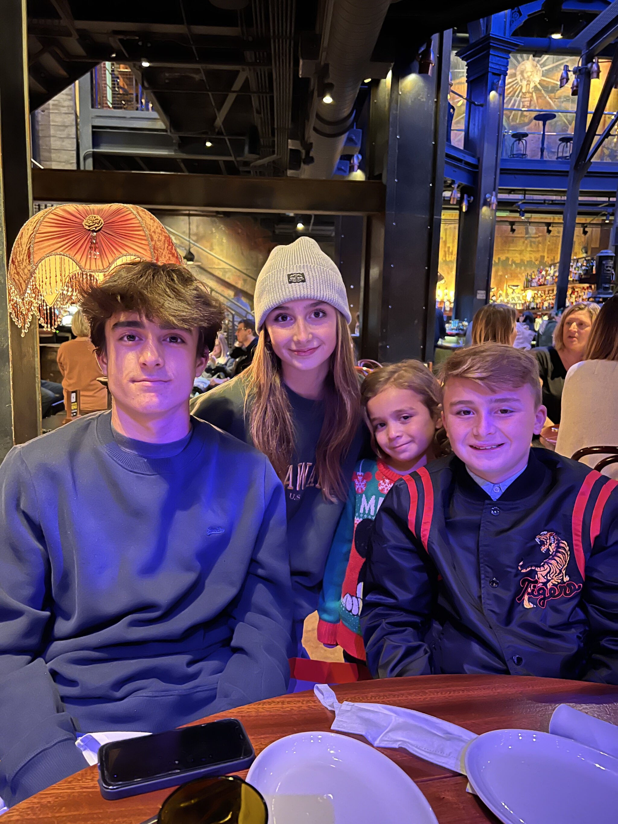 siblings sitting together in a restaurant