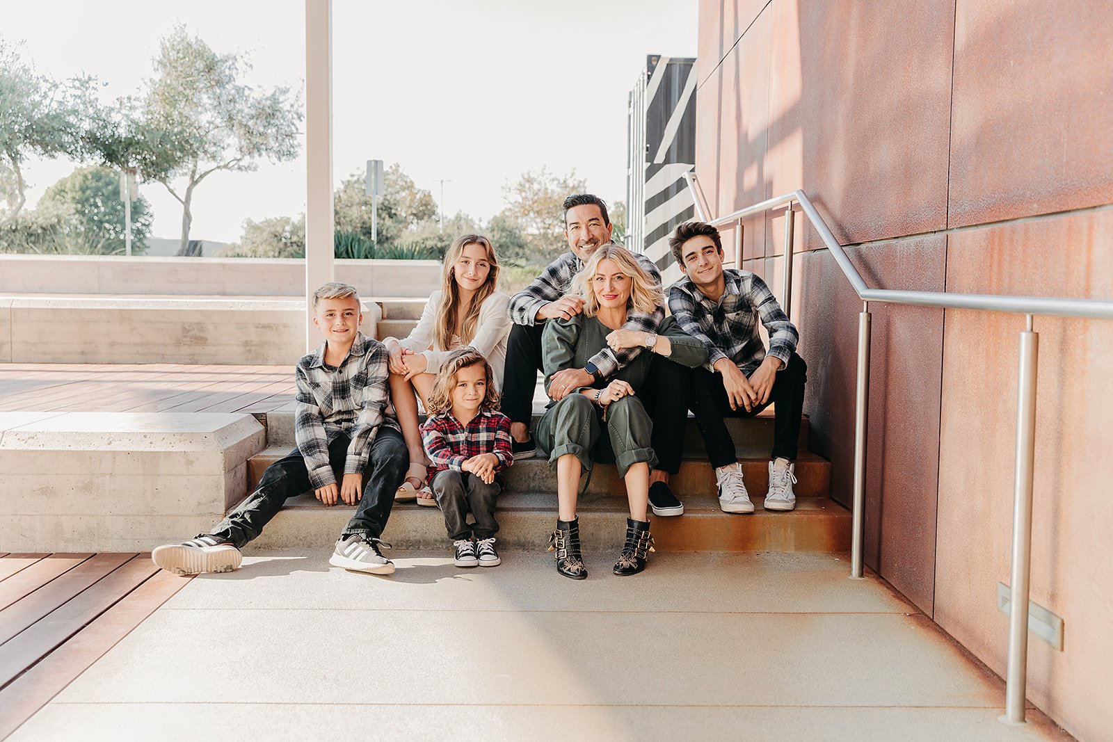 family sitting on the stairs outside