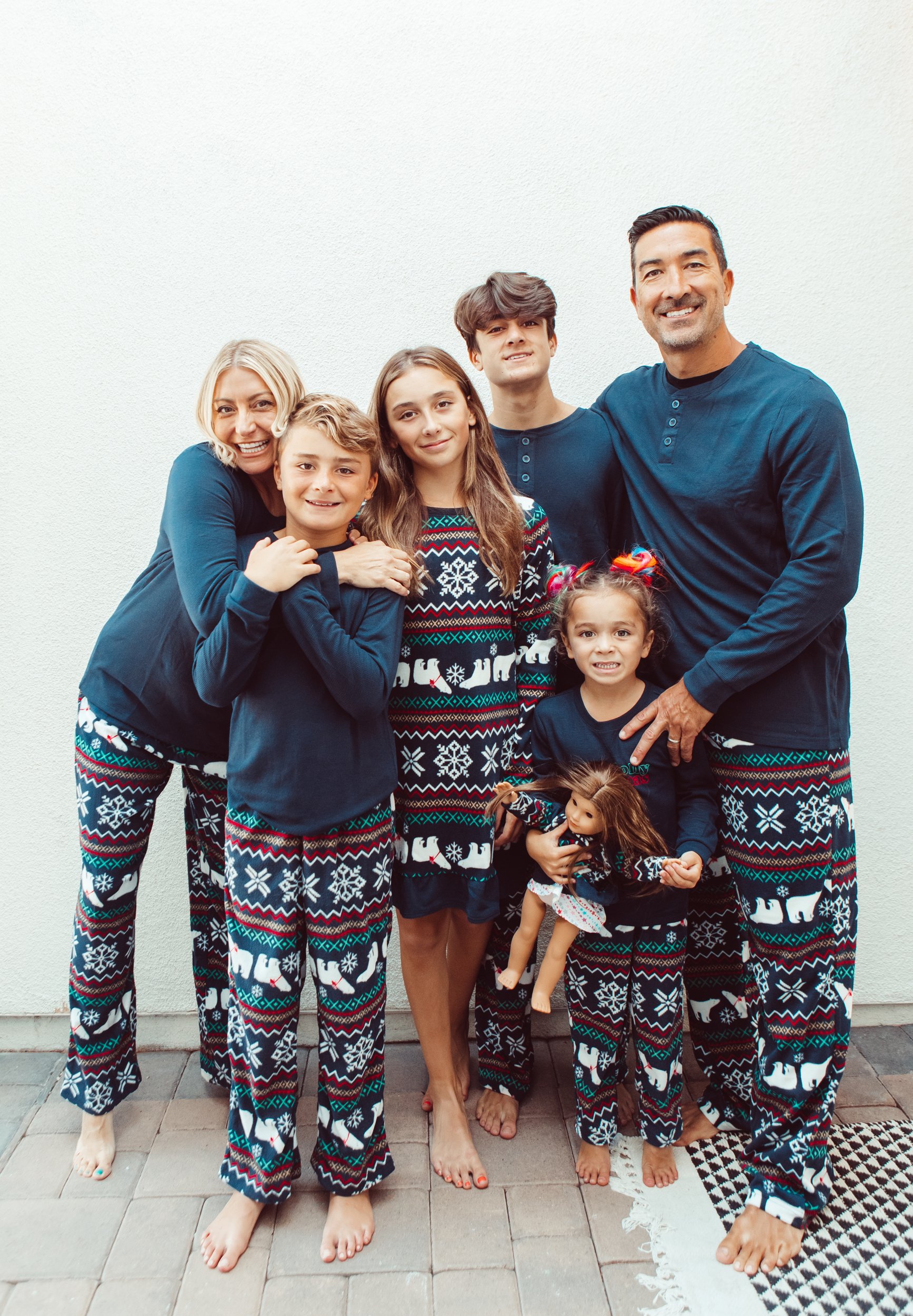 family hugging in matching christmas pajamas