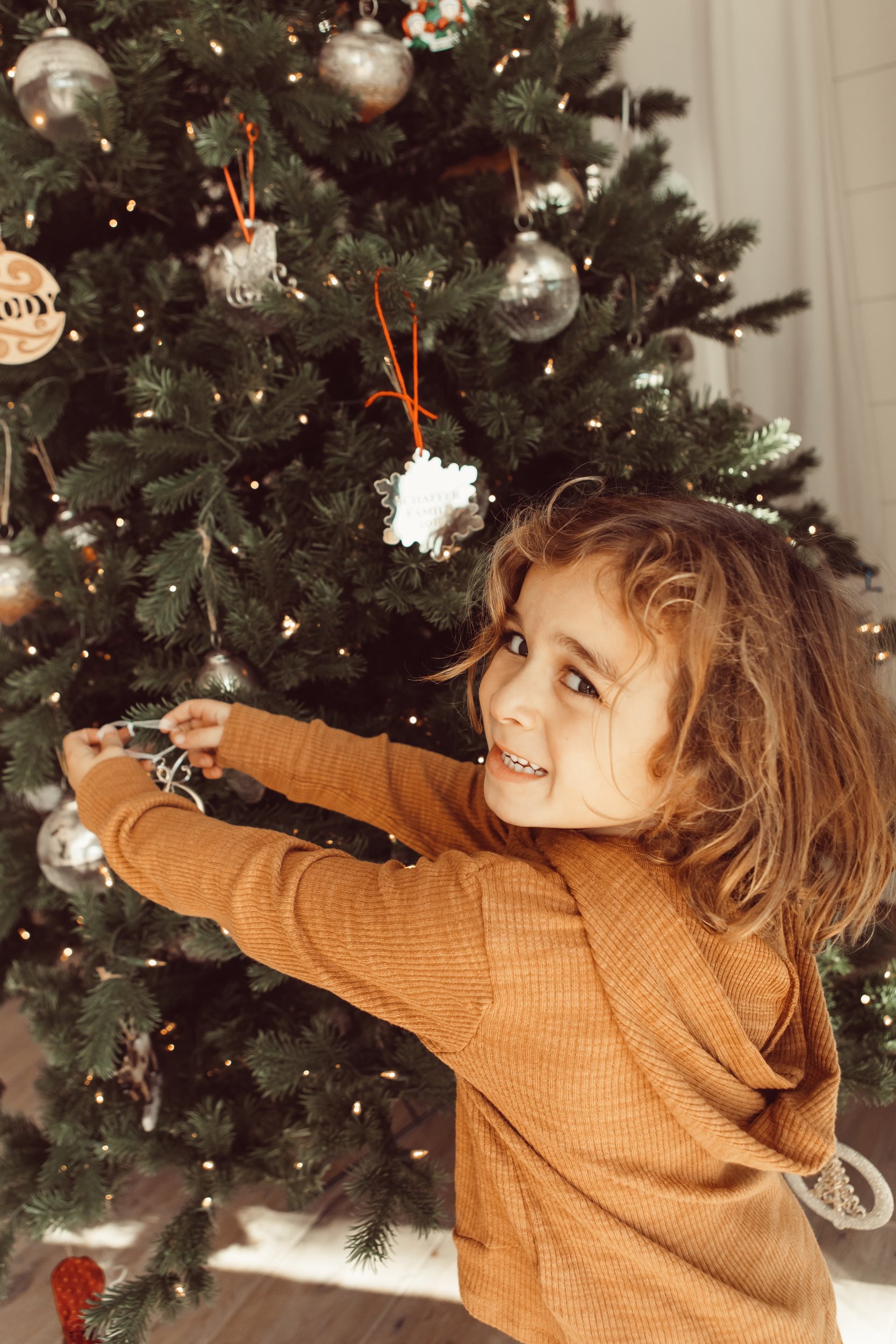 boy decorating christmas tree