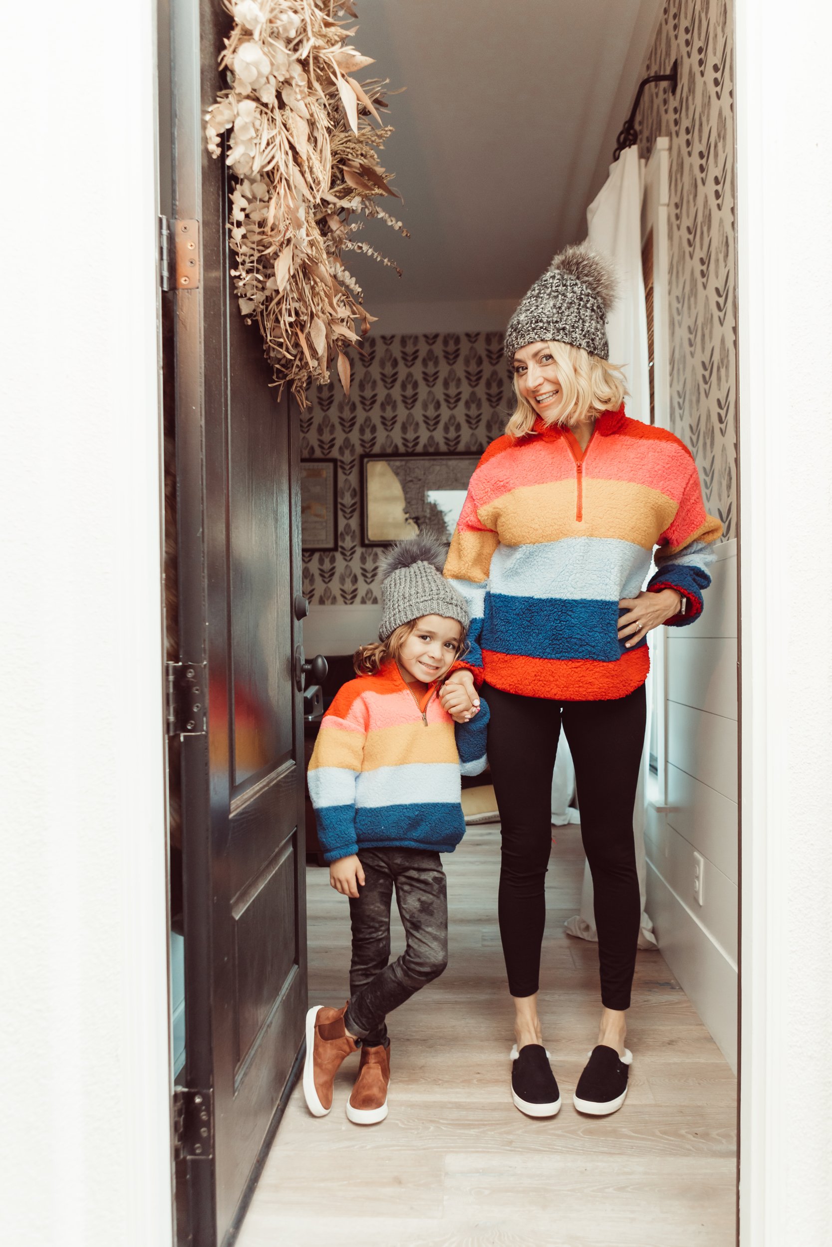 mother and son in matching rainbow jackets