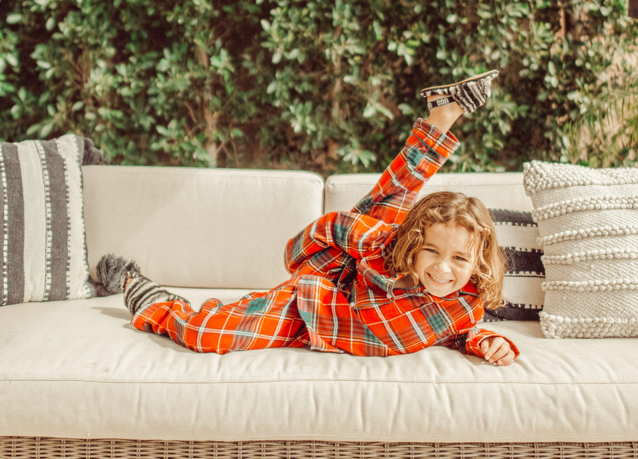 boy dancing in christmas pajamas on couch