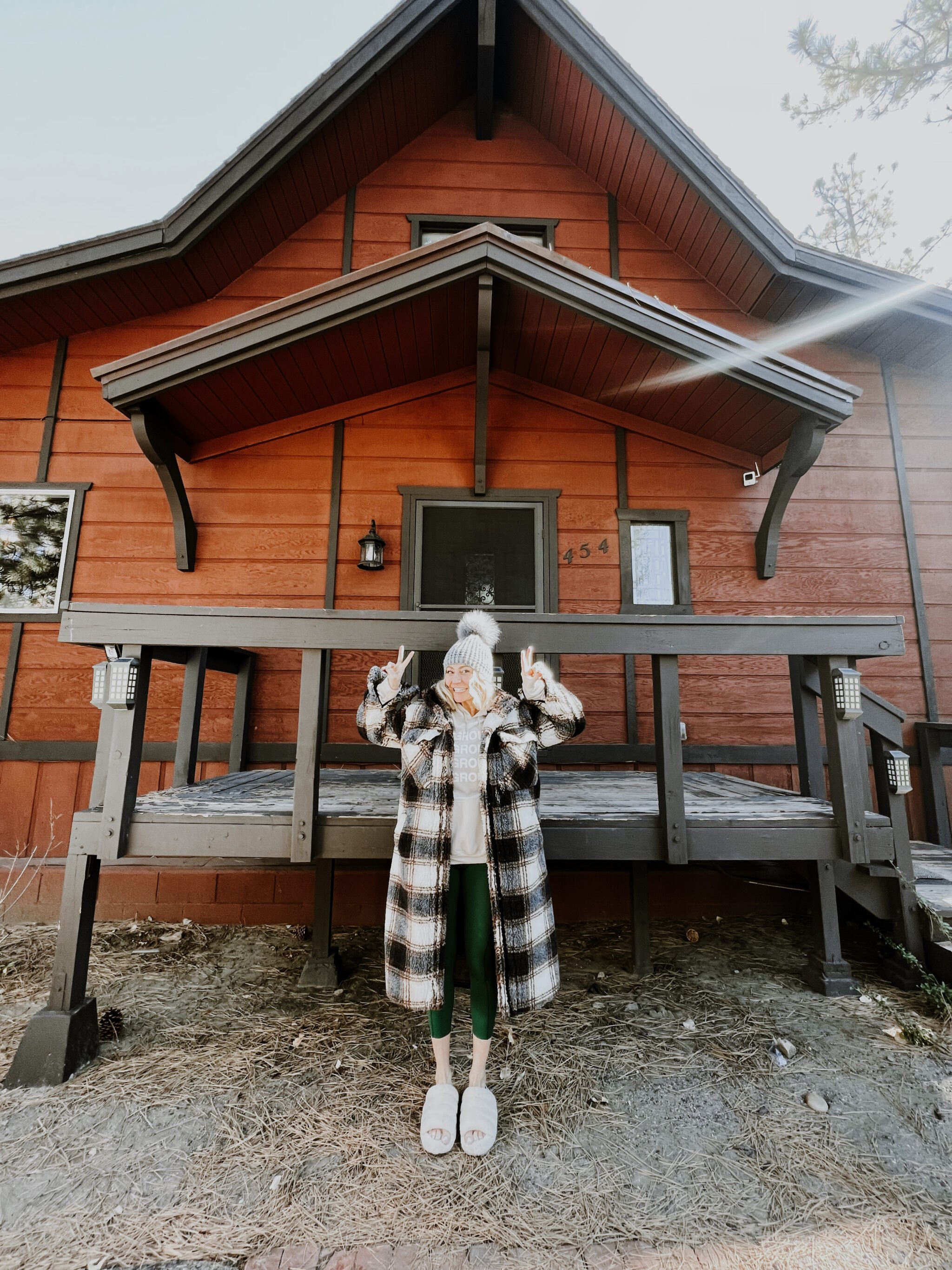 woman standing in front of house