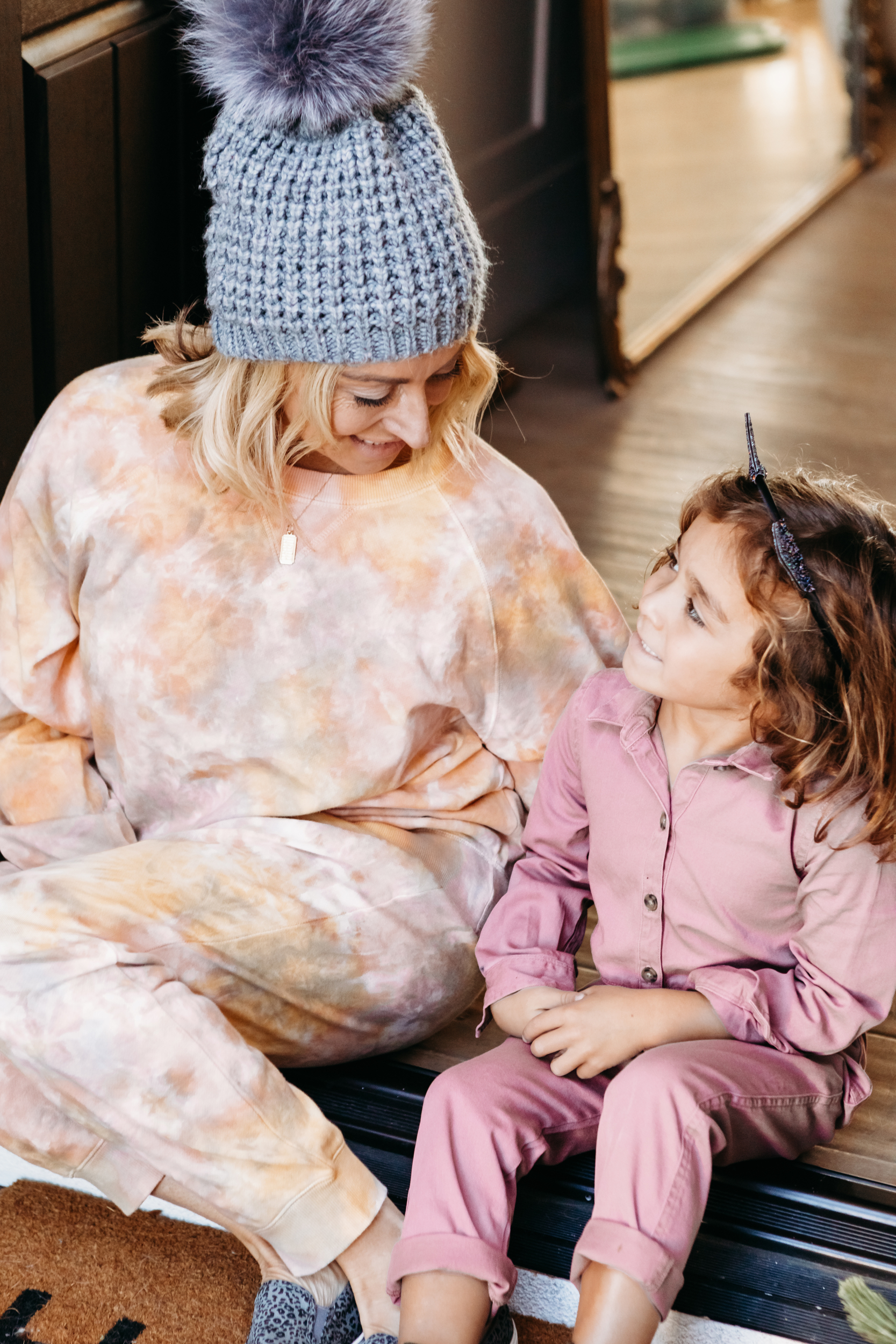 mom sitting in doorway with child