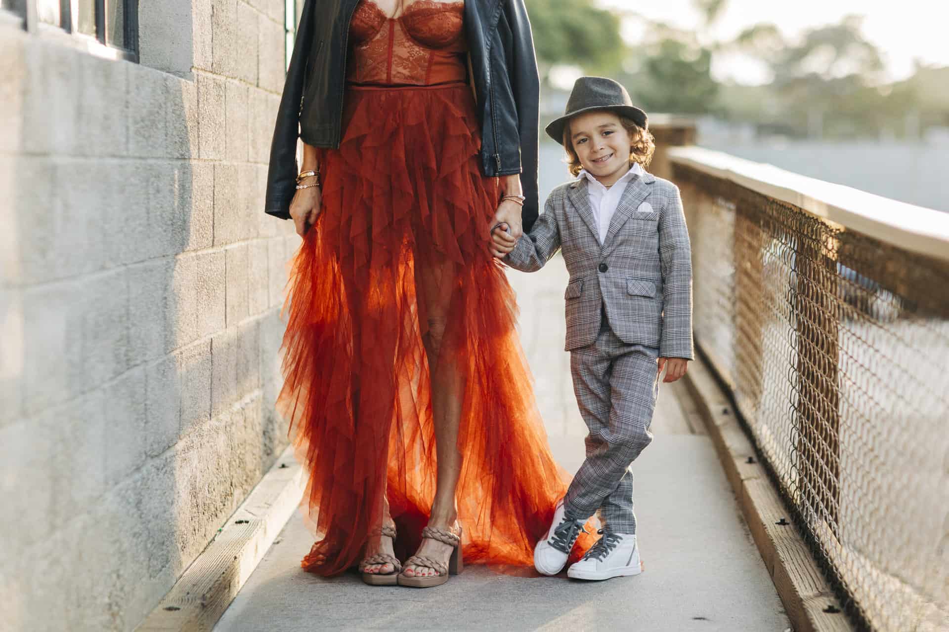 boy holding his mom's hand