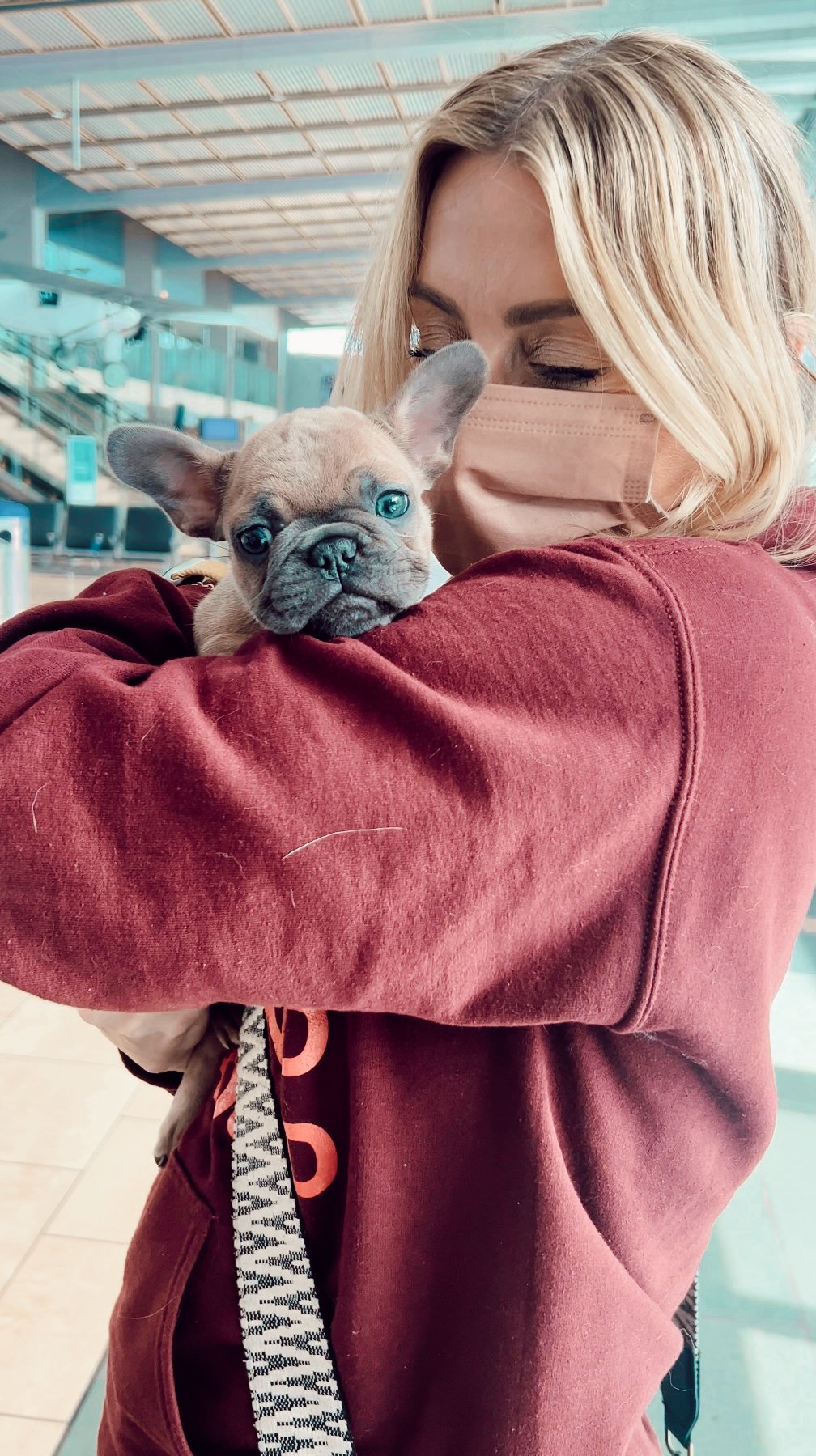 woman holding puppy in her arms