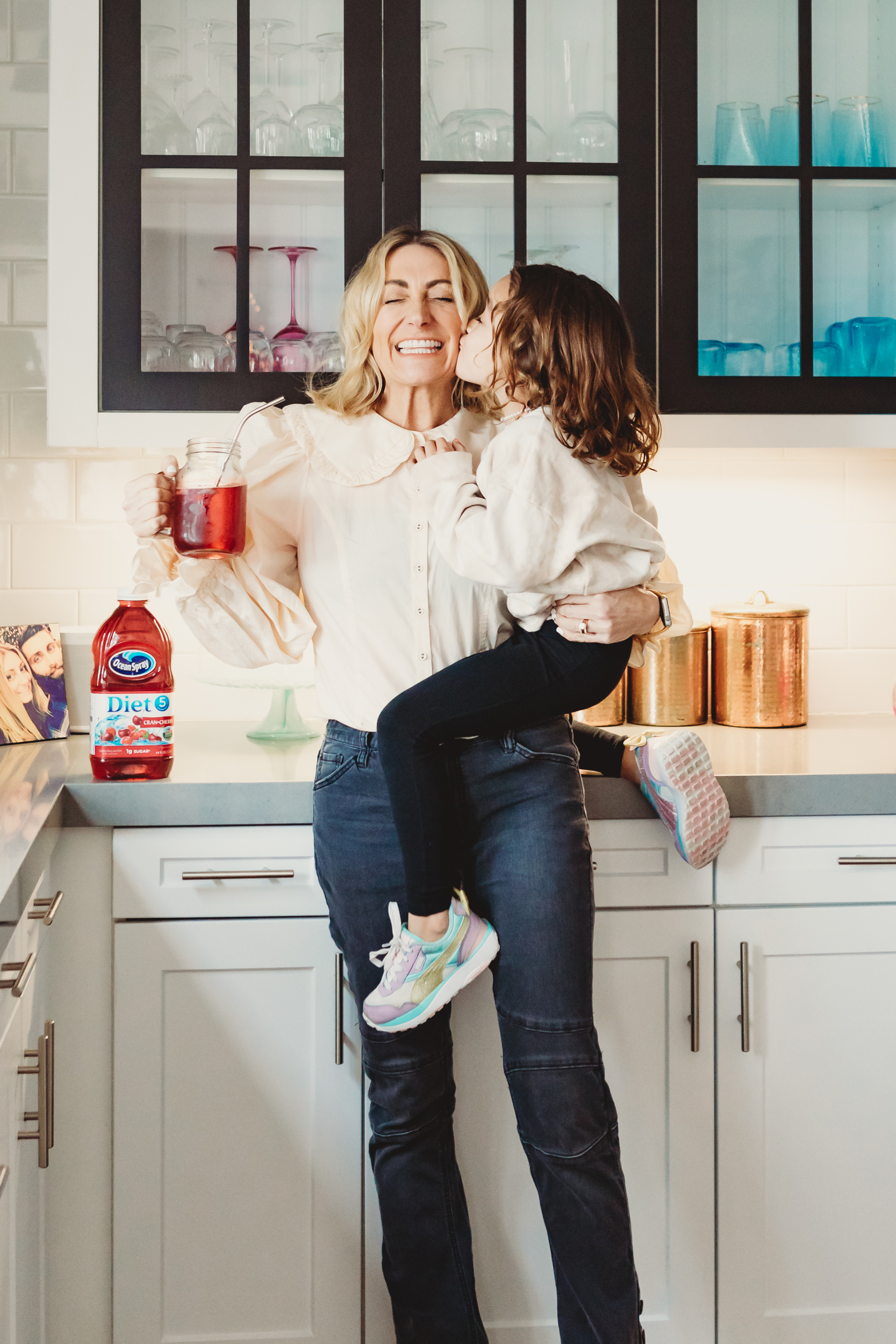 son kissing mom in kitchen