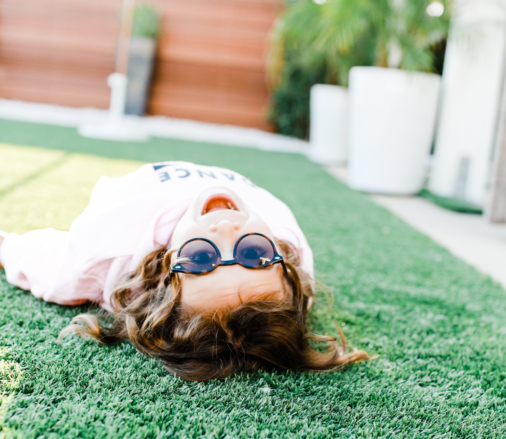 kid rolling in the grass