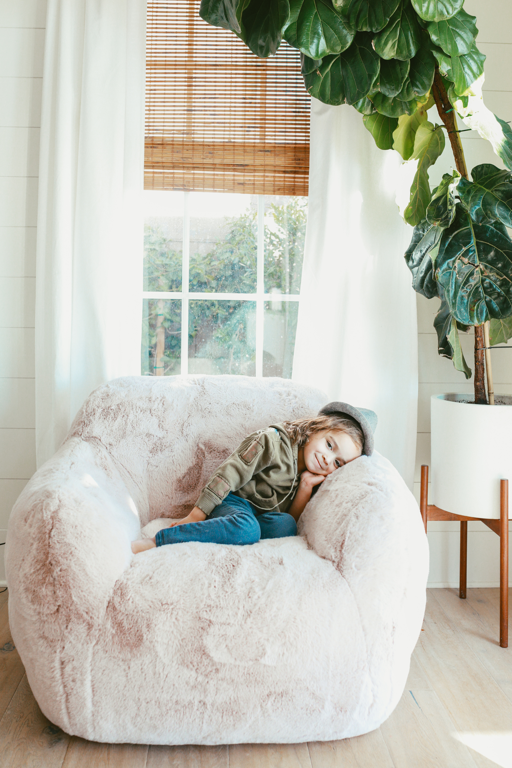 boy sitting in overstuffed chair