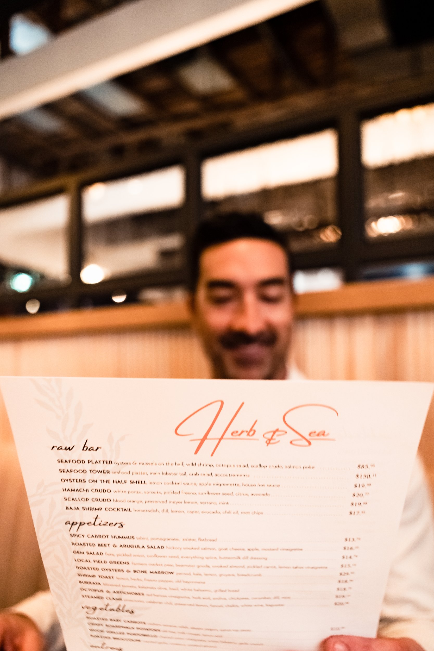 man reading a restaurant menu