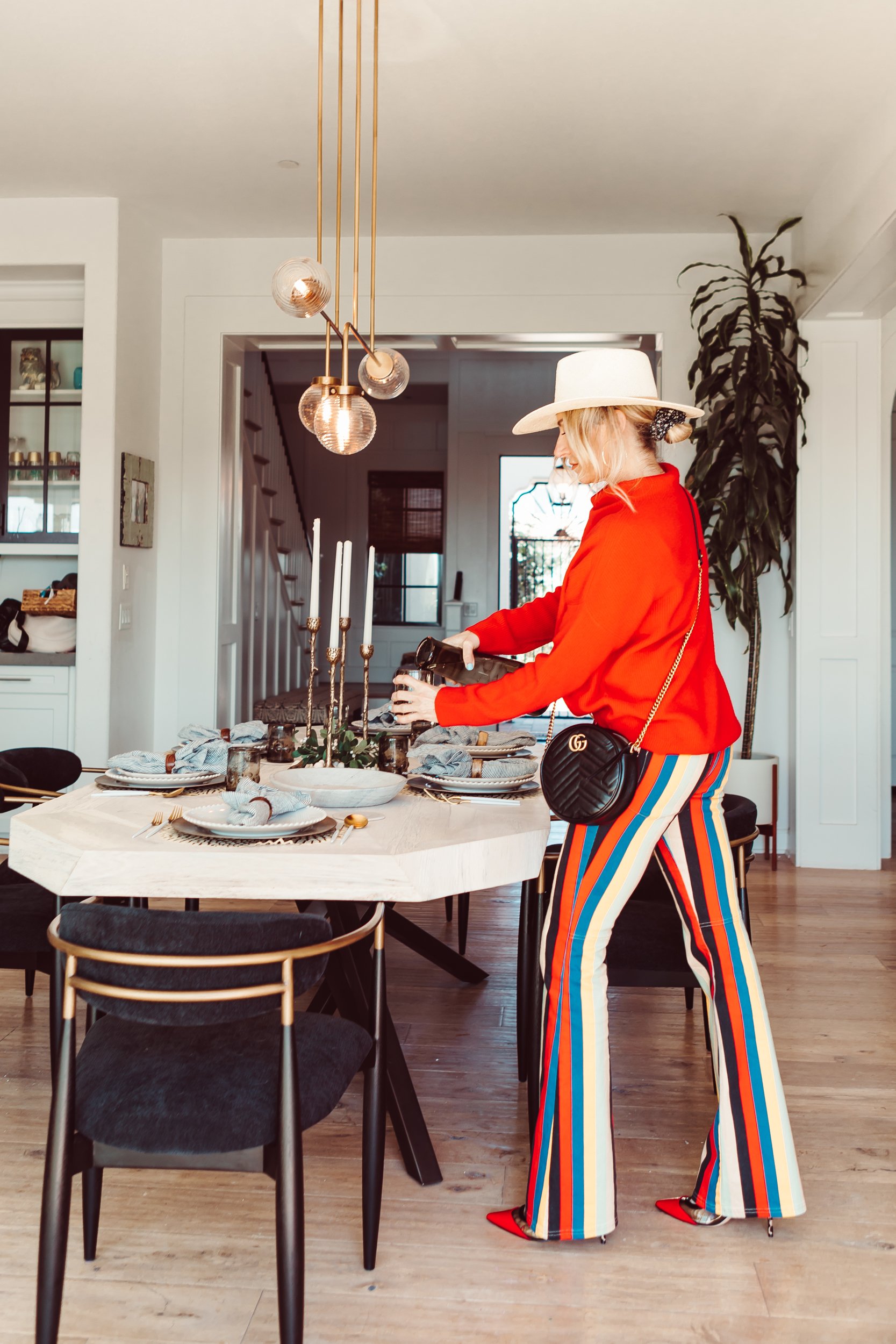 woman pouring water at table