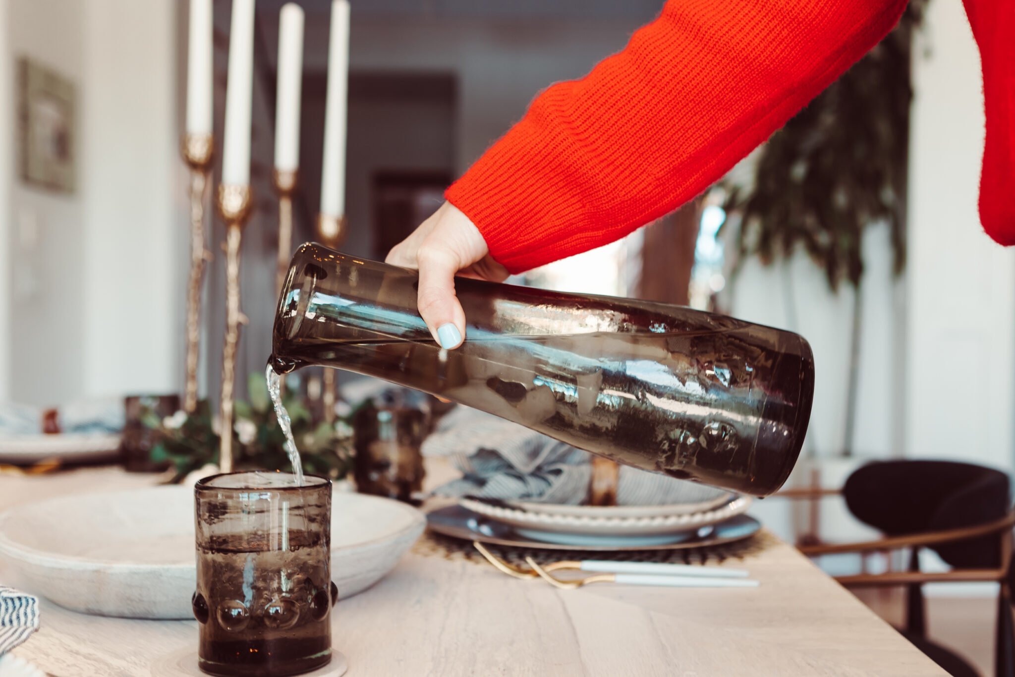 woman pouring water into glass