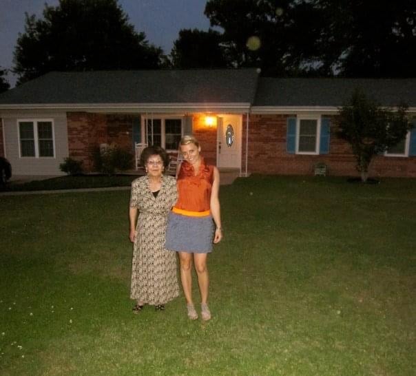 women standing on front lawn