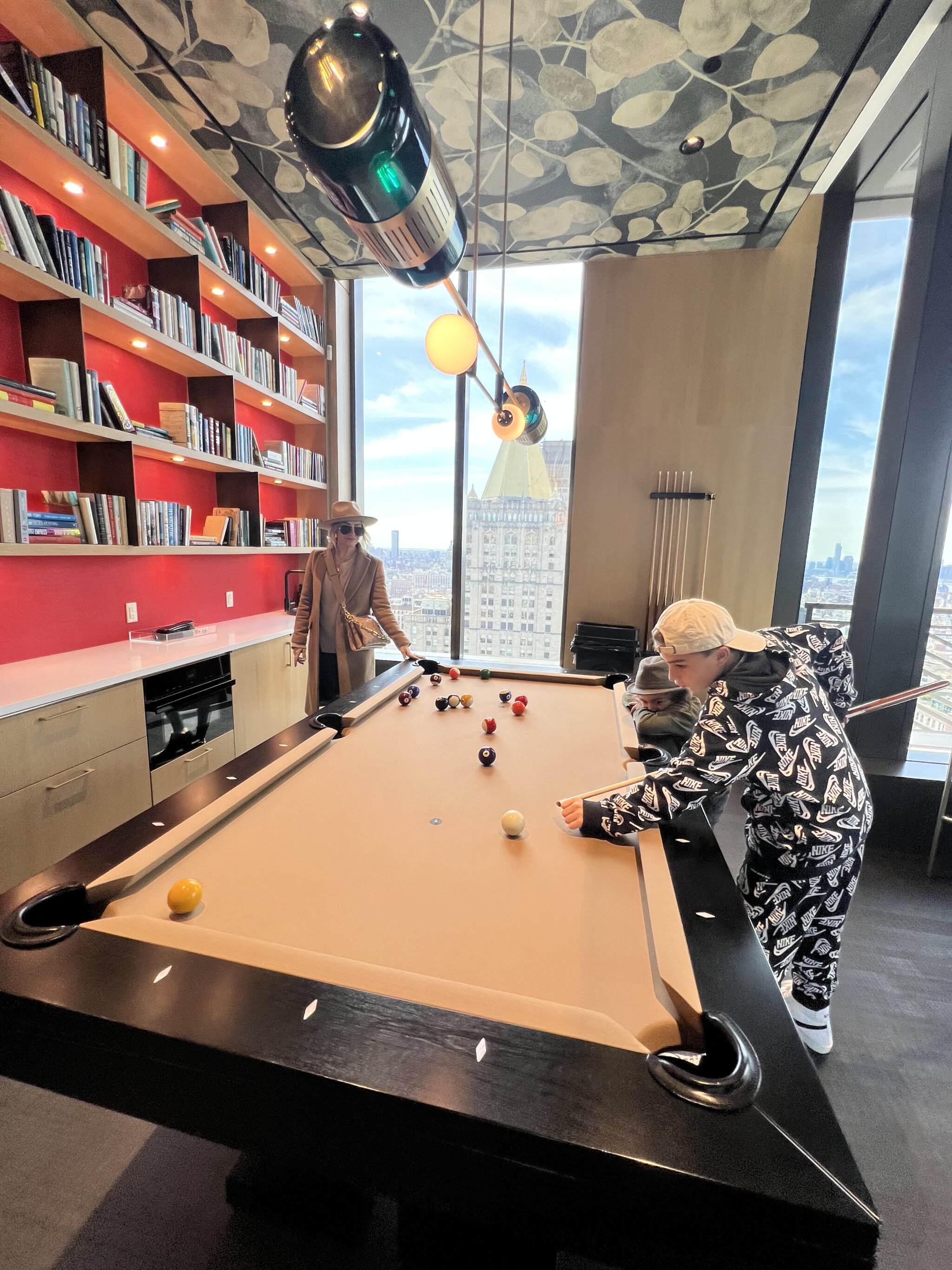 mom and sons playing billiards