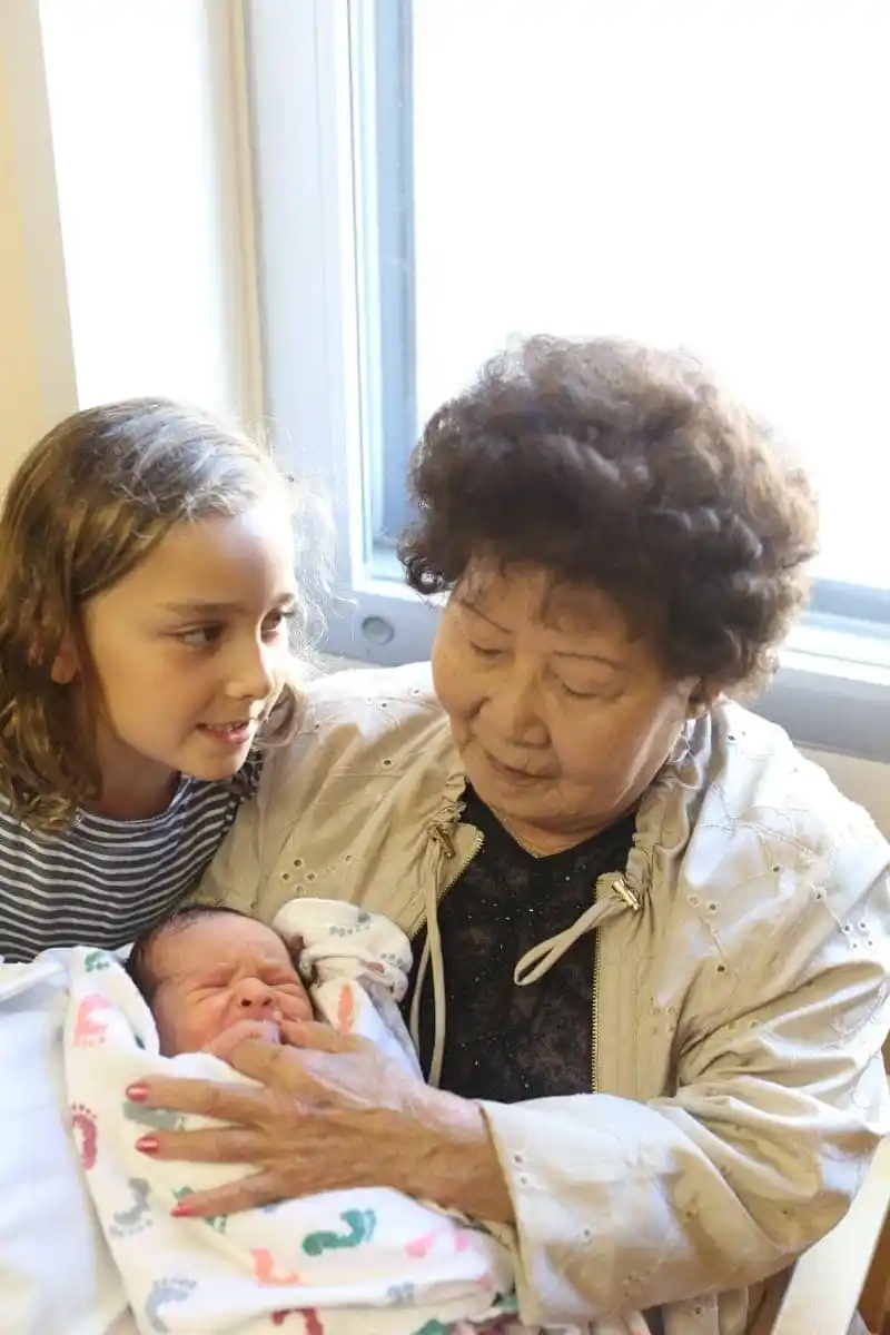 grandma holding newborn grandson