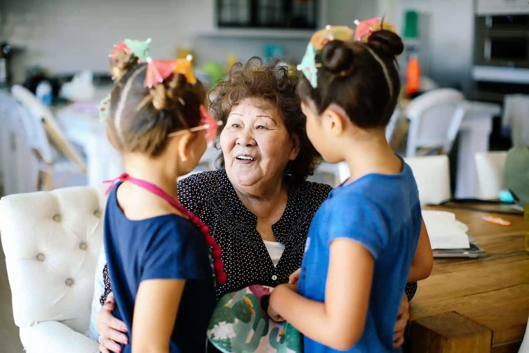 grandma holding her granddaughters