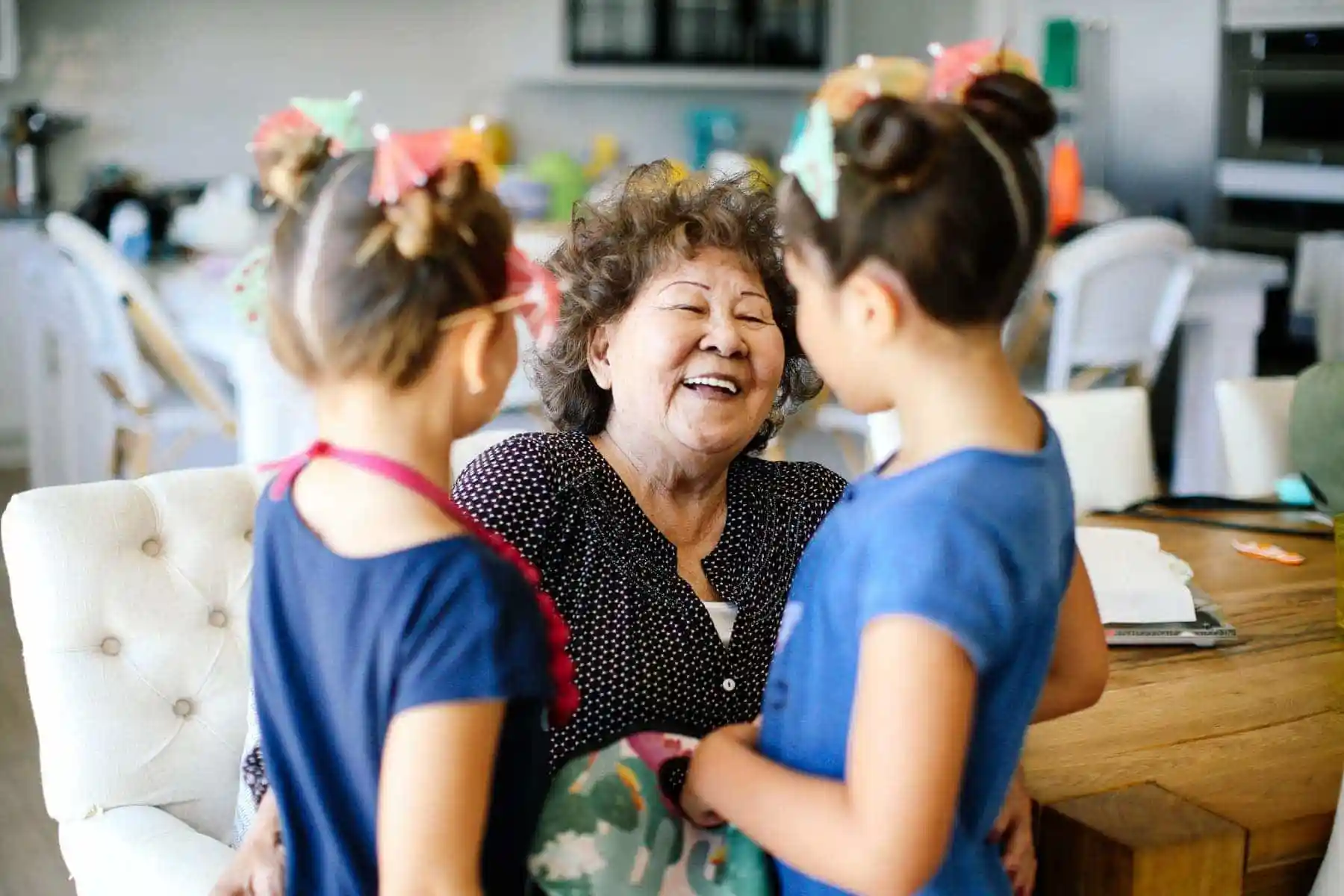 grandma laughing with her granddaughters