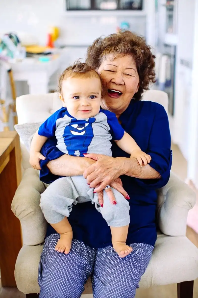 happy grandma holding her grandson