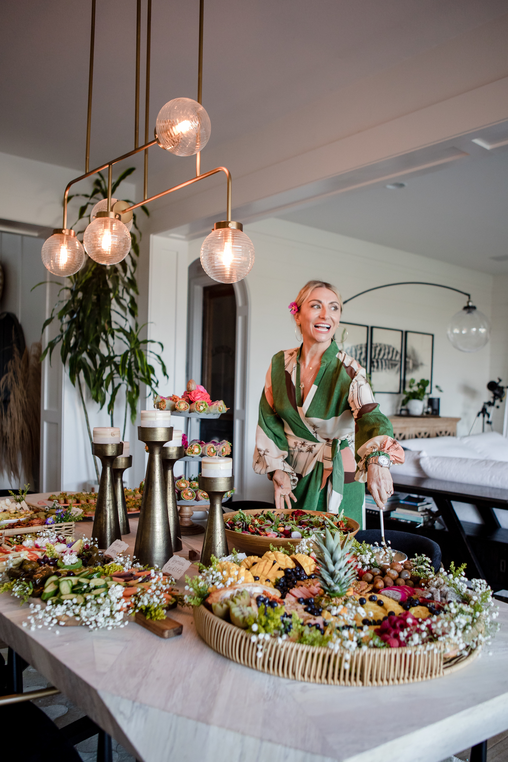 woman standing next to table with food