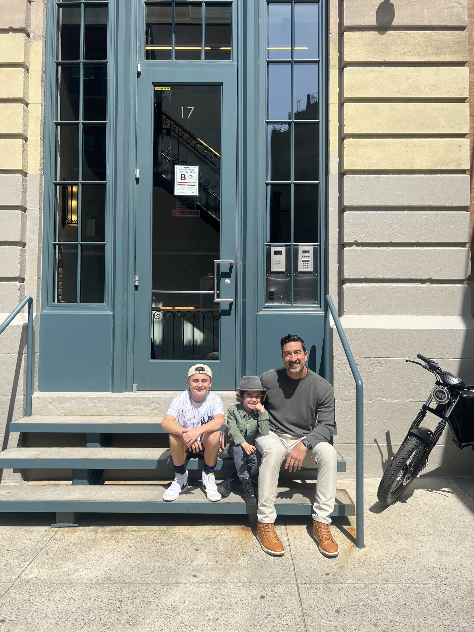 father with sons sitting on steps