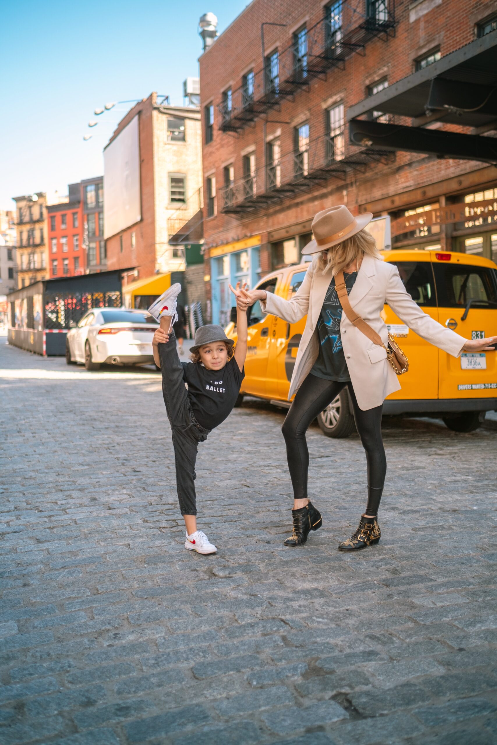 mom and son dancing in the streets in new york