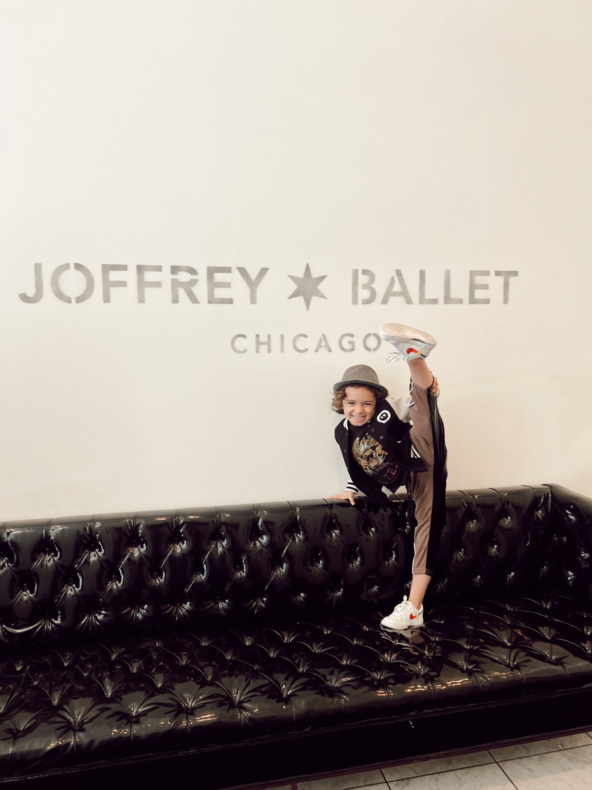 boy doing ballet on a couch