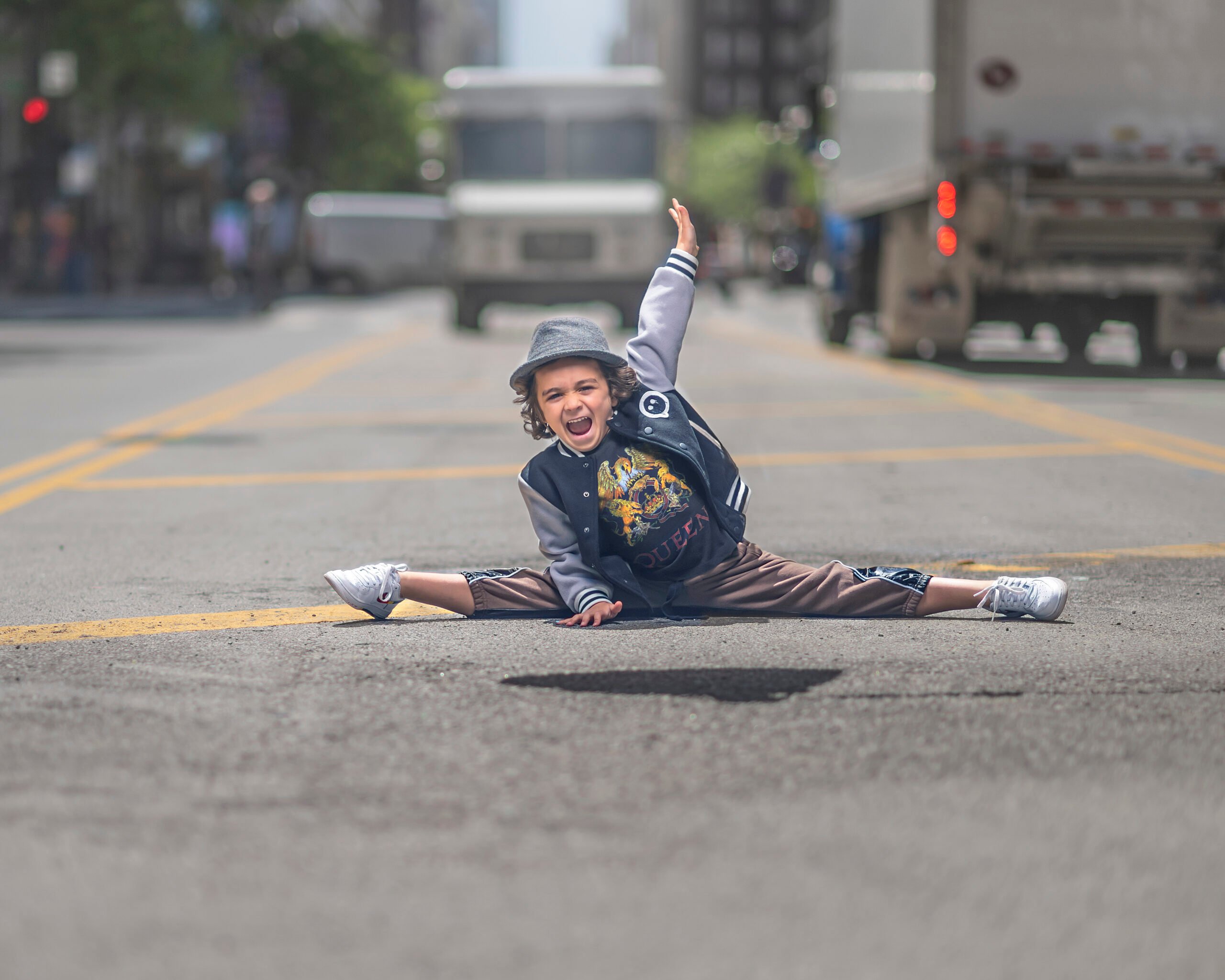 boy doing the splits in the street