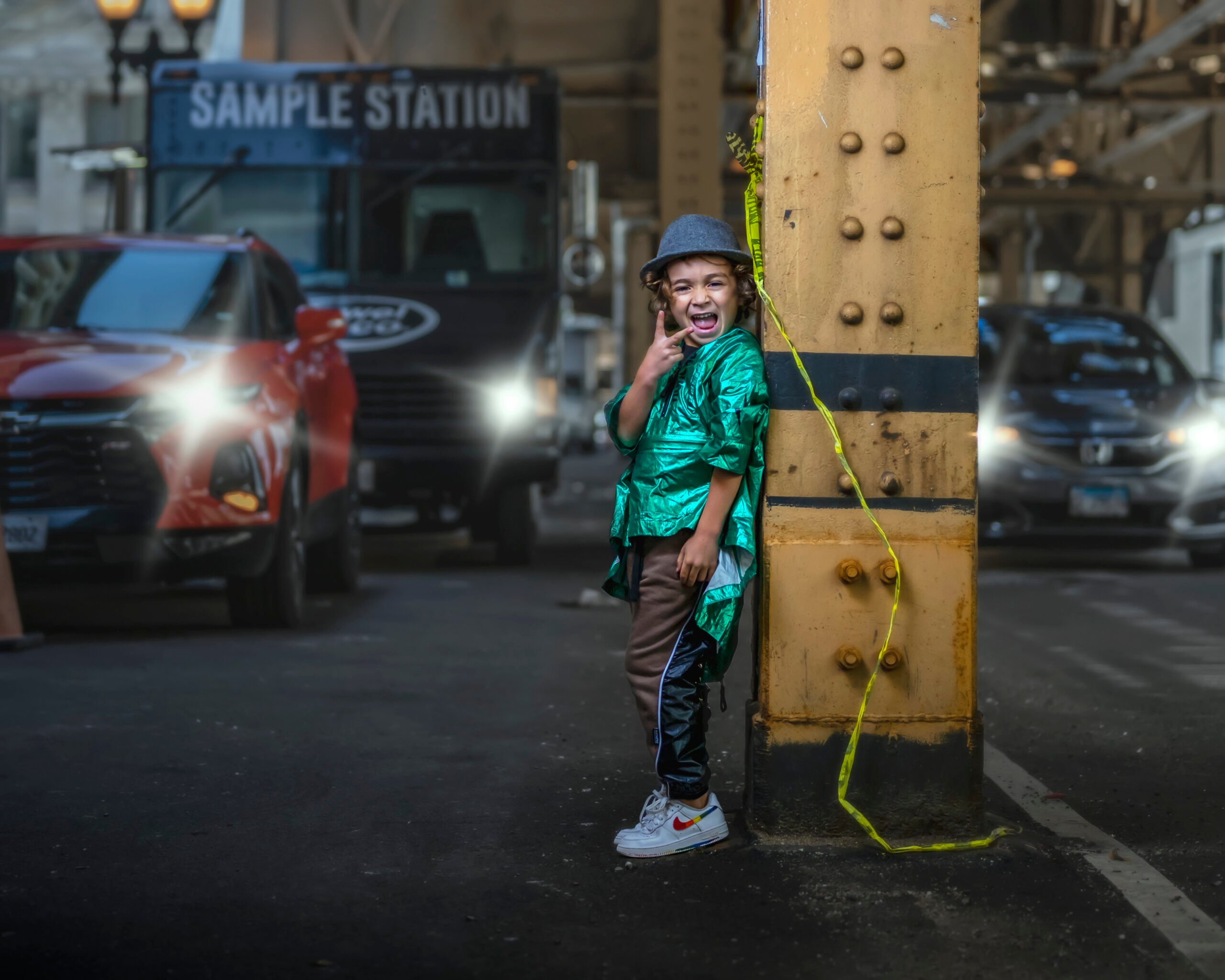 boy leaning on metal post