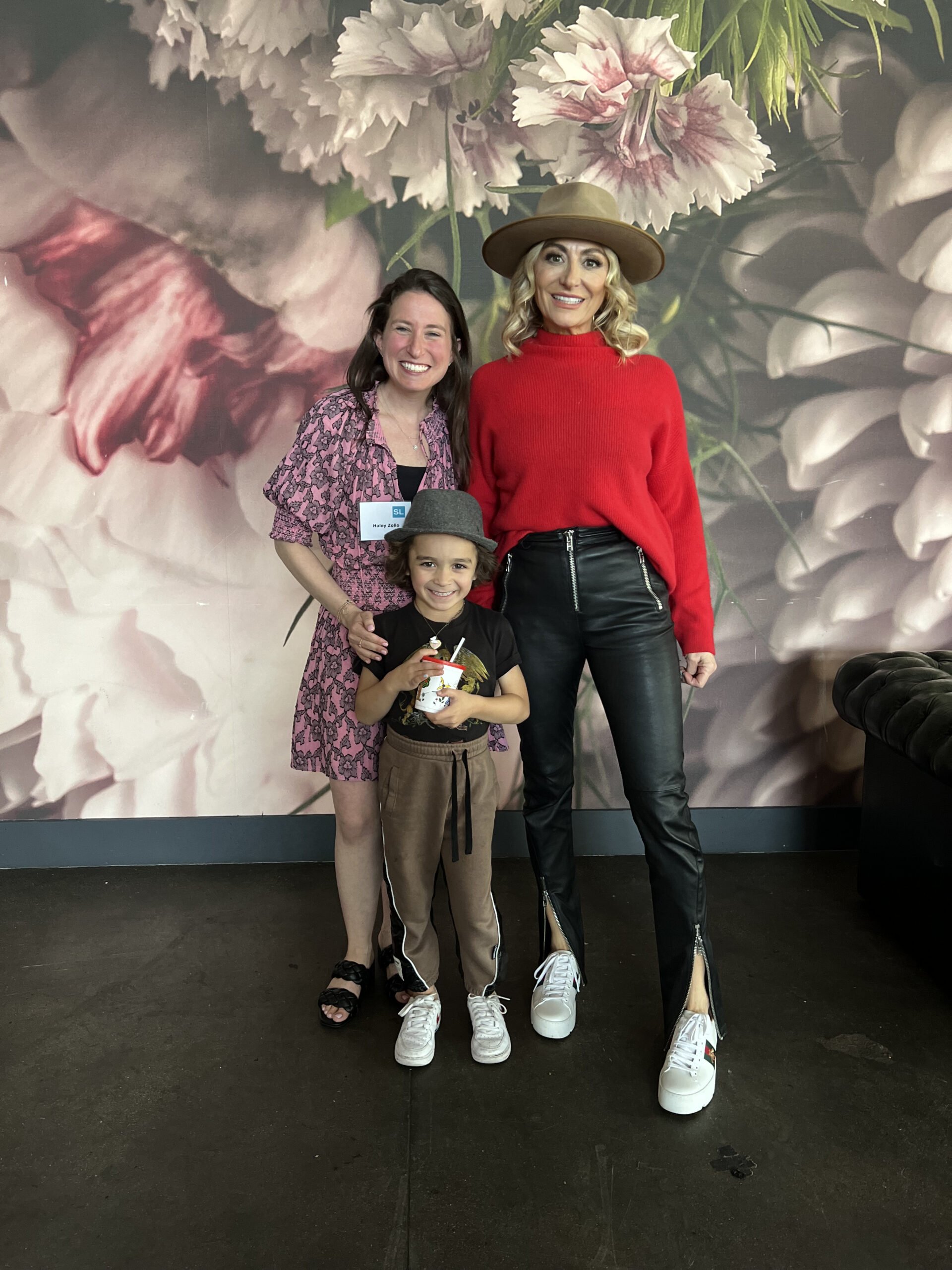 two women standing with boy