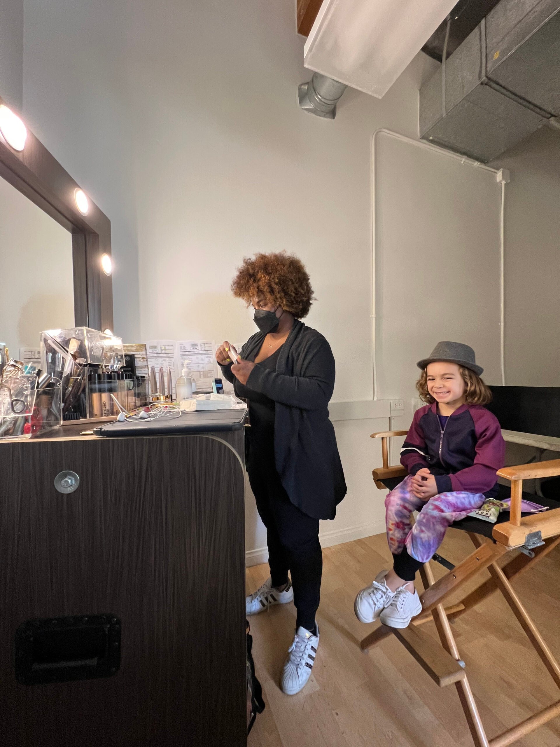 kid getting ready with makeup artist
