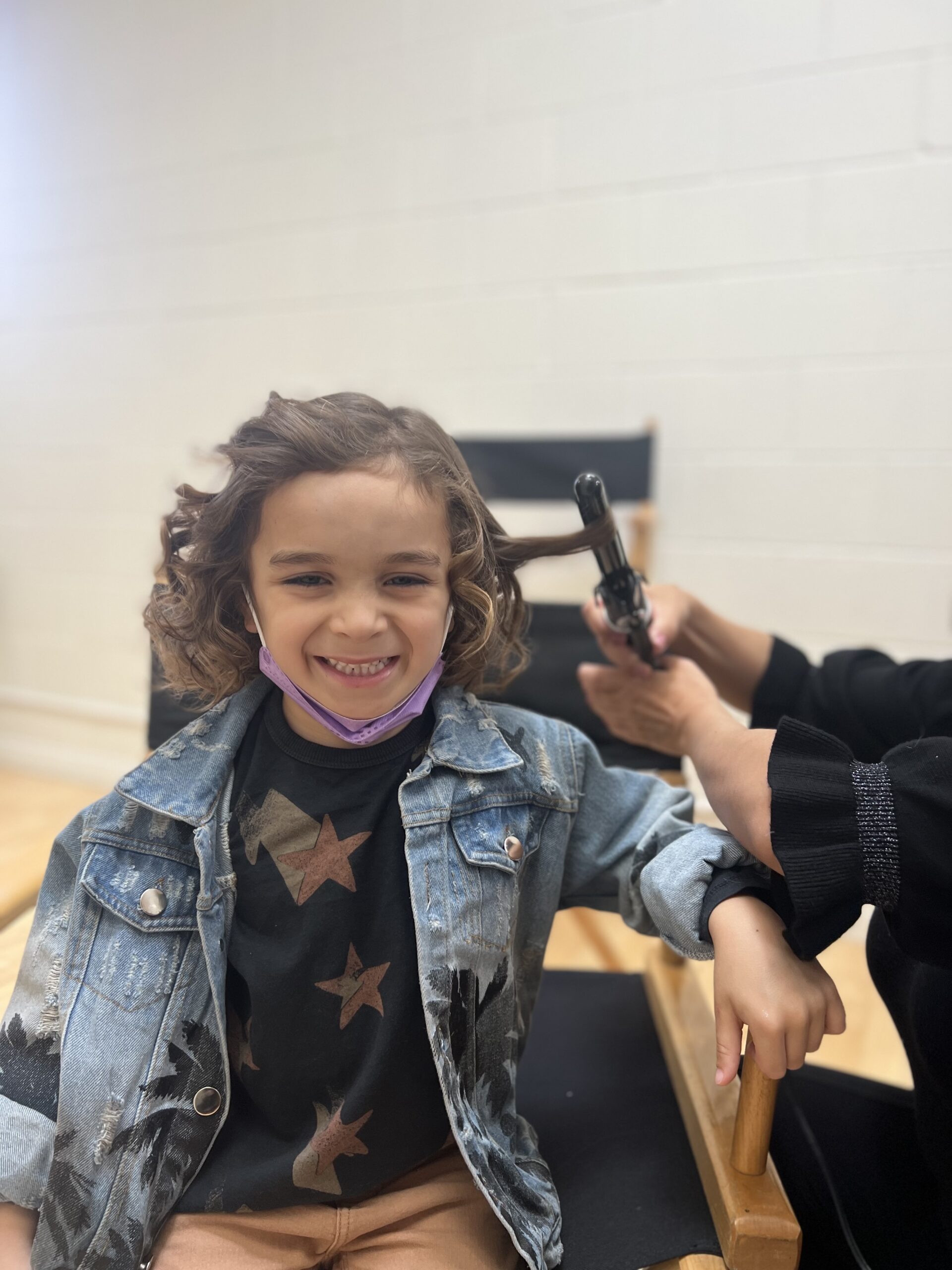 boy getting his hair curled