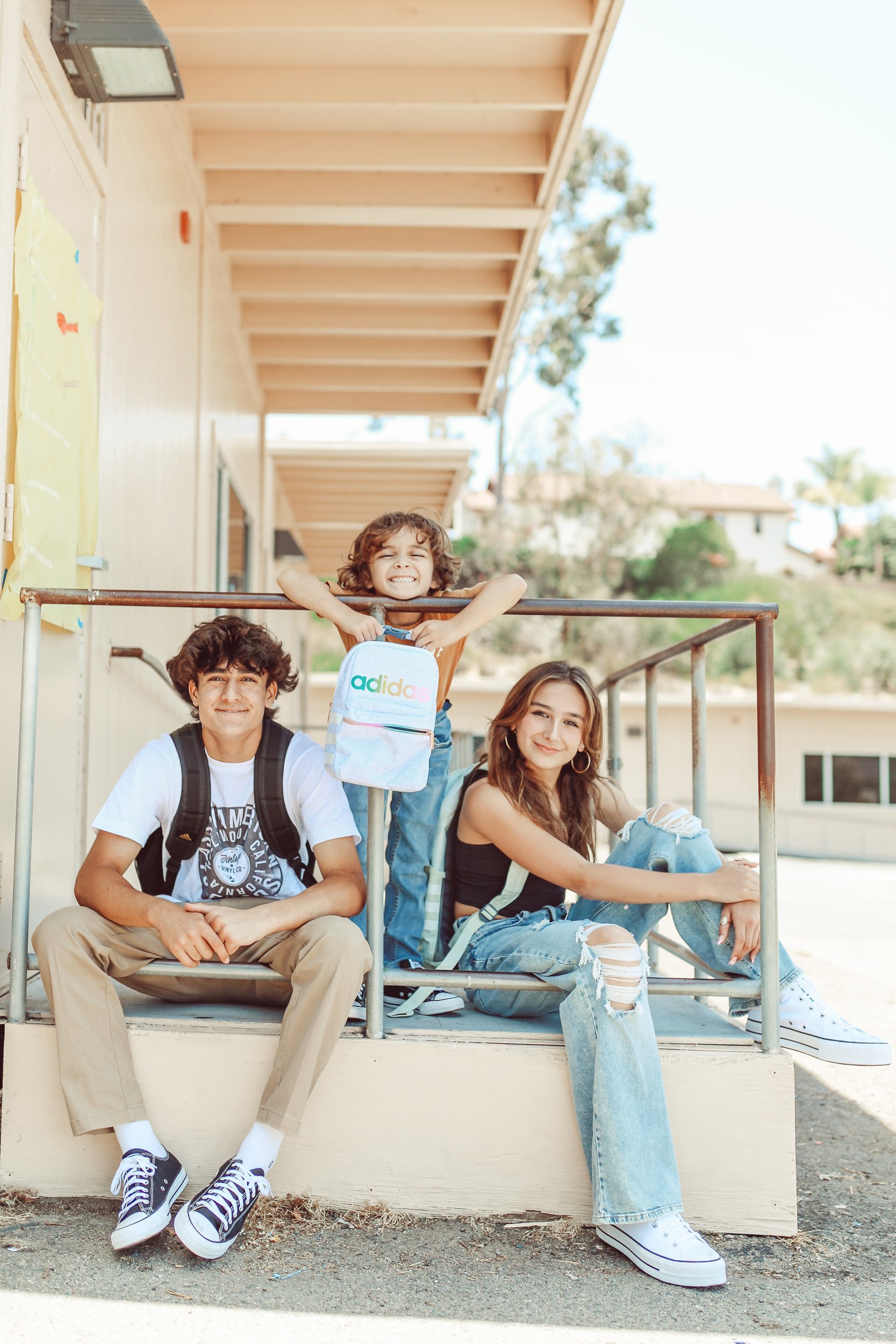 kids sitting outside the classroom