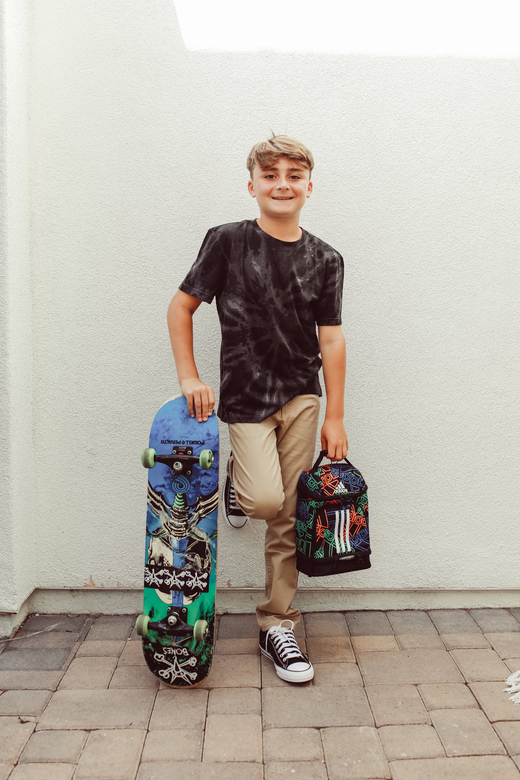 boy standing with skateboard