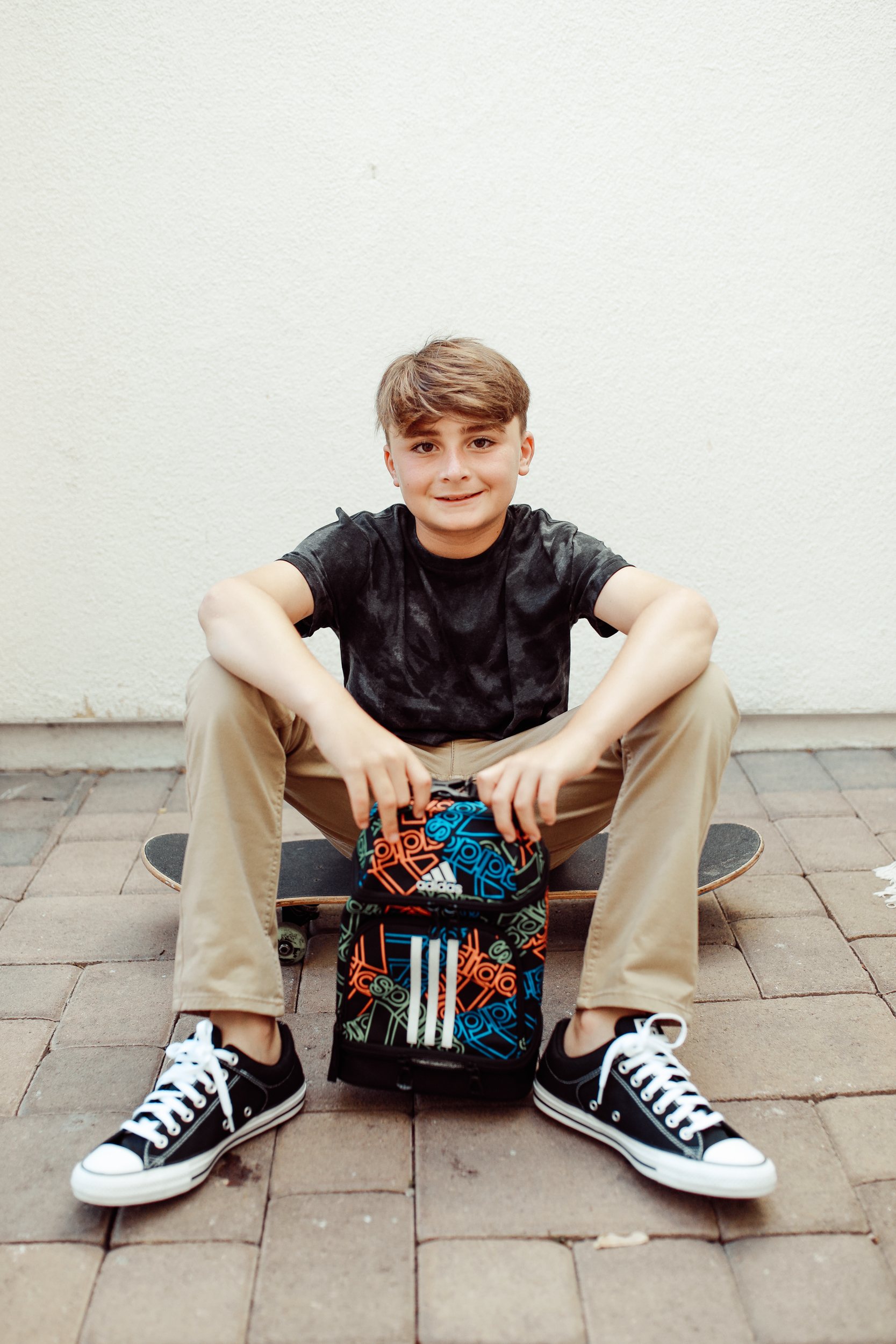 boy sitting on a skateboard