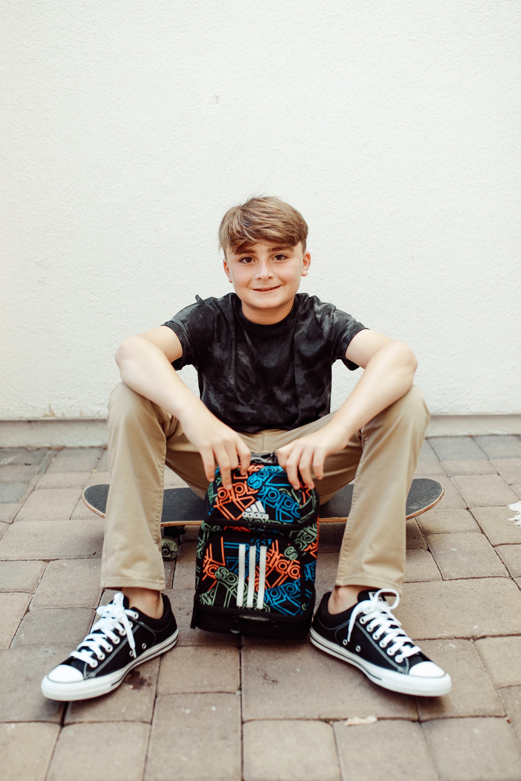 boy sitting with his lunchbox