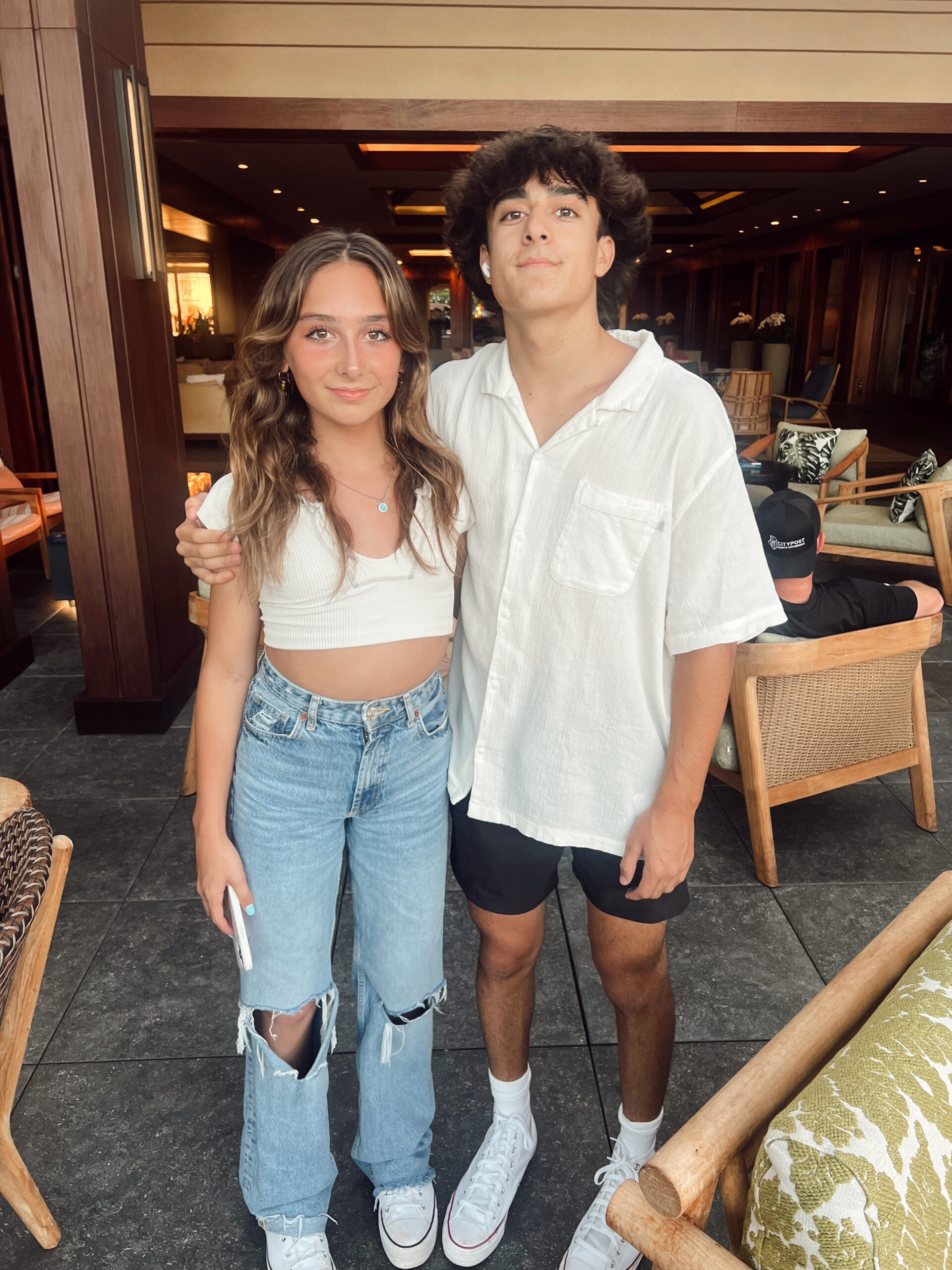 teen siblings standing together