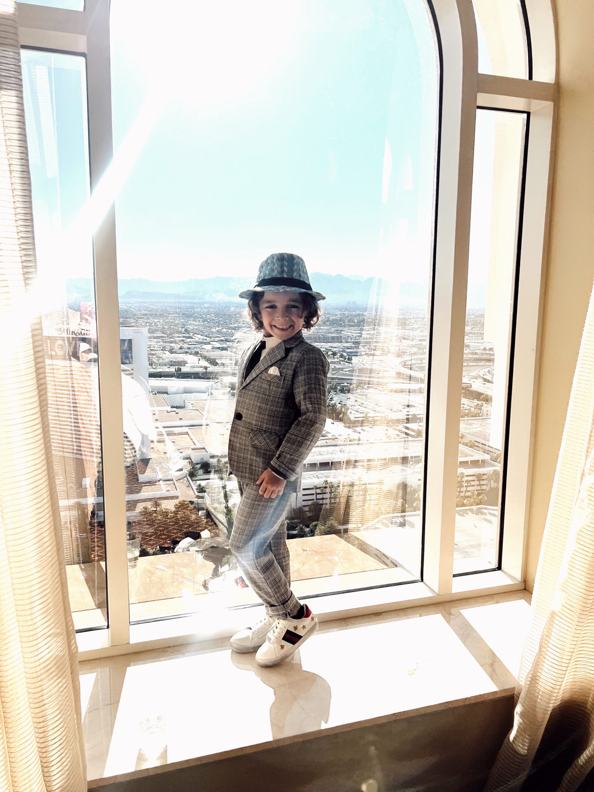 boy standing skyscraper window