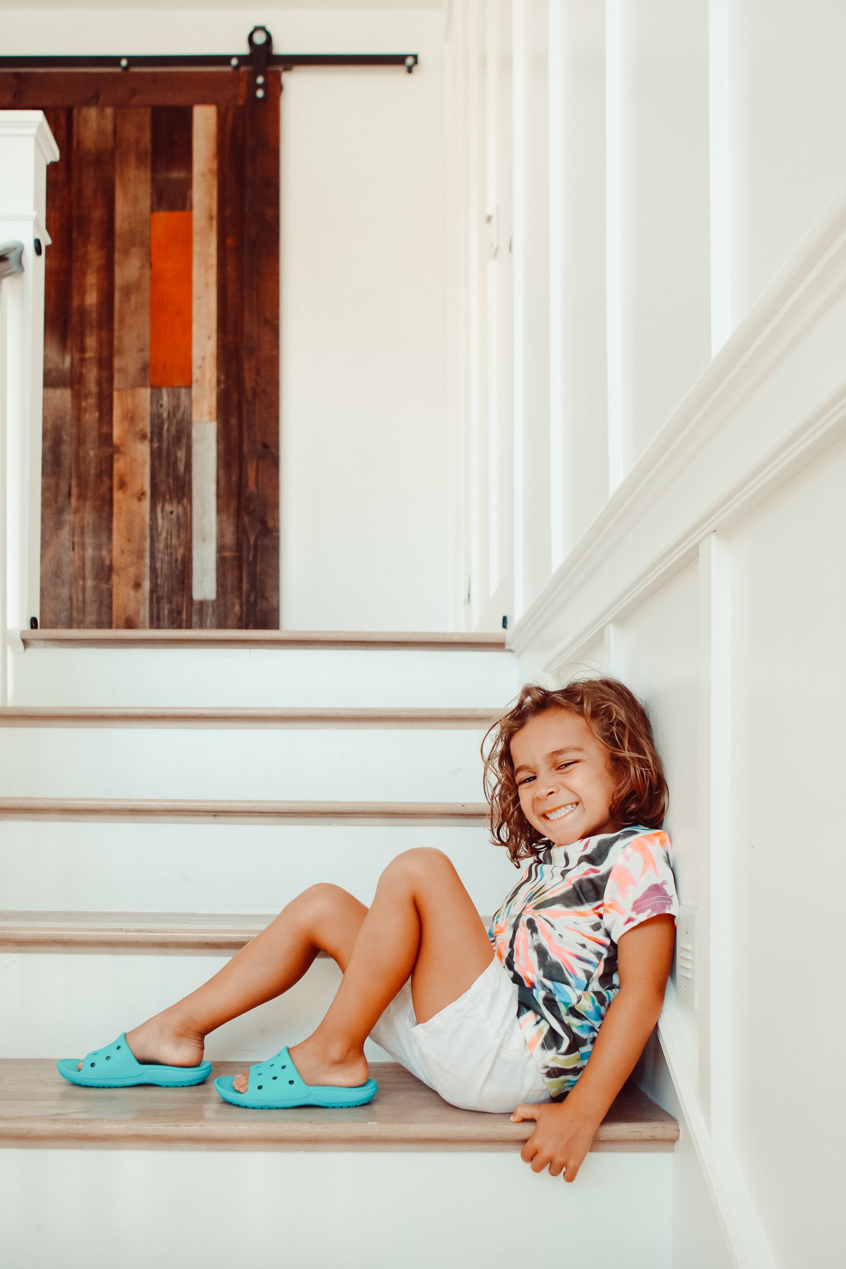 smiling boy sitting on stairs